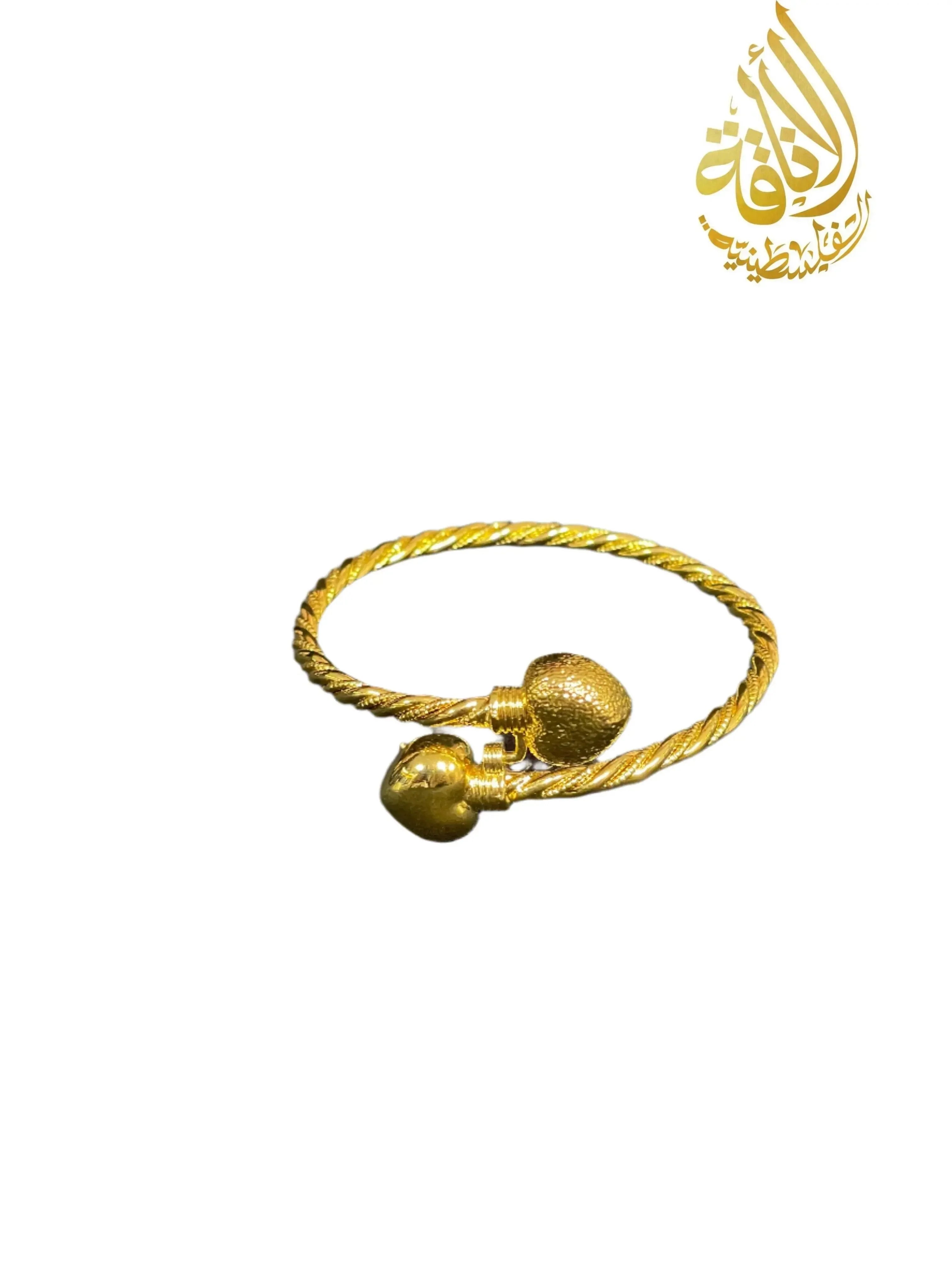 Mabroma Gold Heart Bracelet by Palestinian Elegance with twisted band and two heart-shaped ends