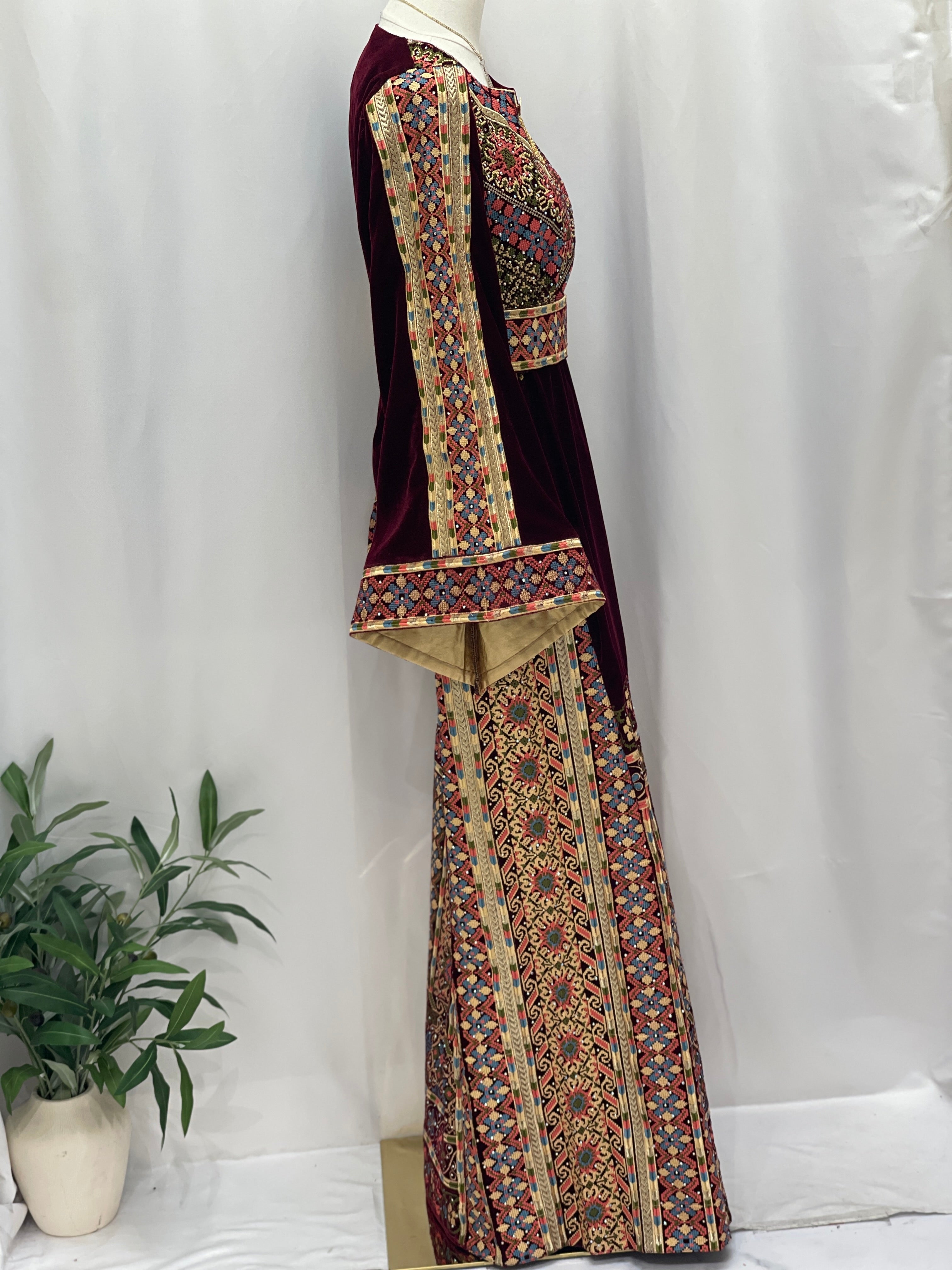 Side view of Maise Velvet Embroidered Thoub with intricate patterns and elegant bell sleeves