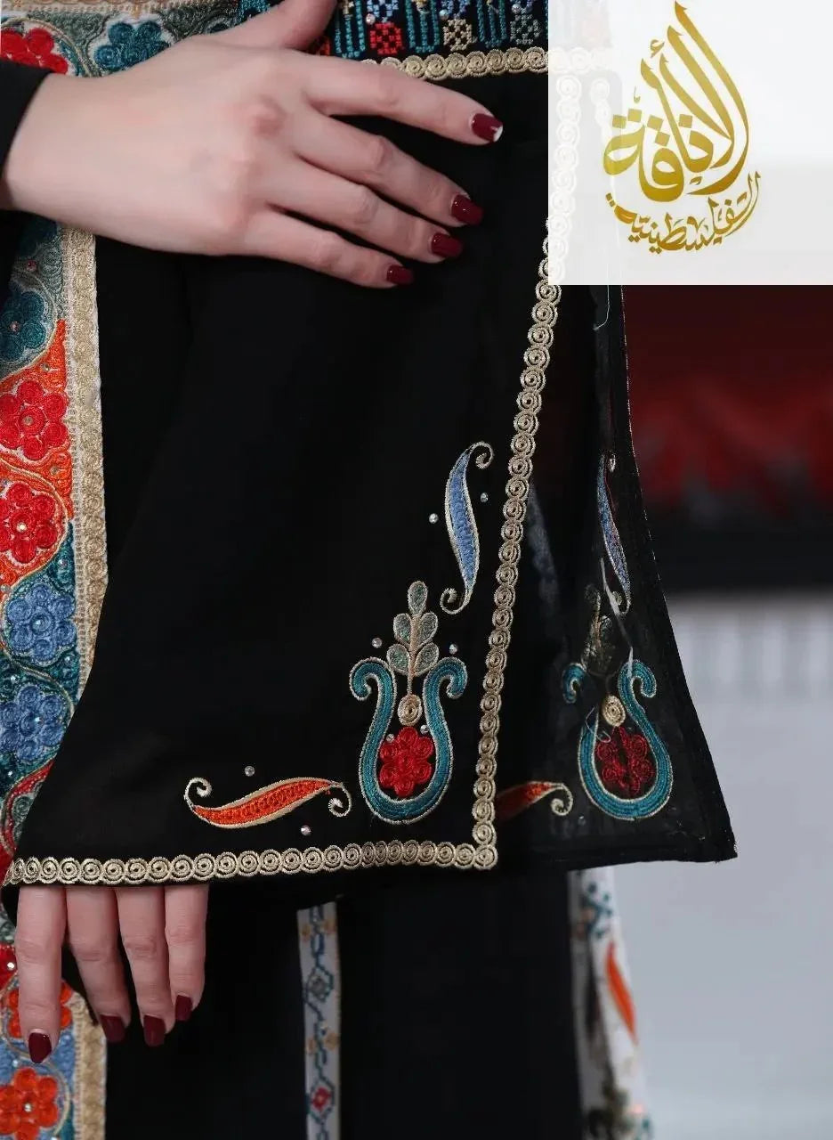 Close-up of Malaki embroidered kaftan sleeve with intricate colorful embroidery and decorative trim