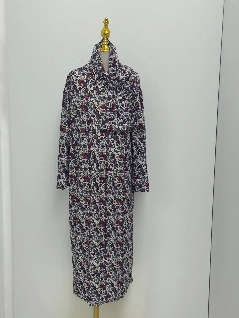 Palestinian Elegance Full Prayer Dress in navy and burgundy floral print with long sleeves and modest cowl neck on mannequin