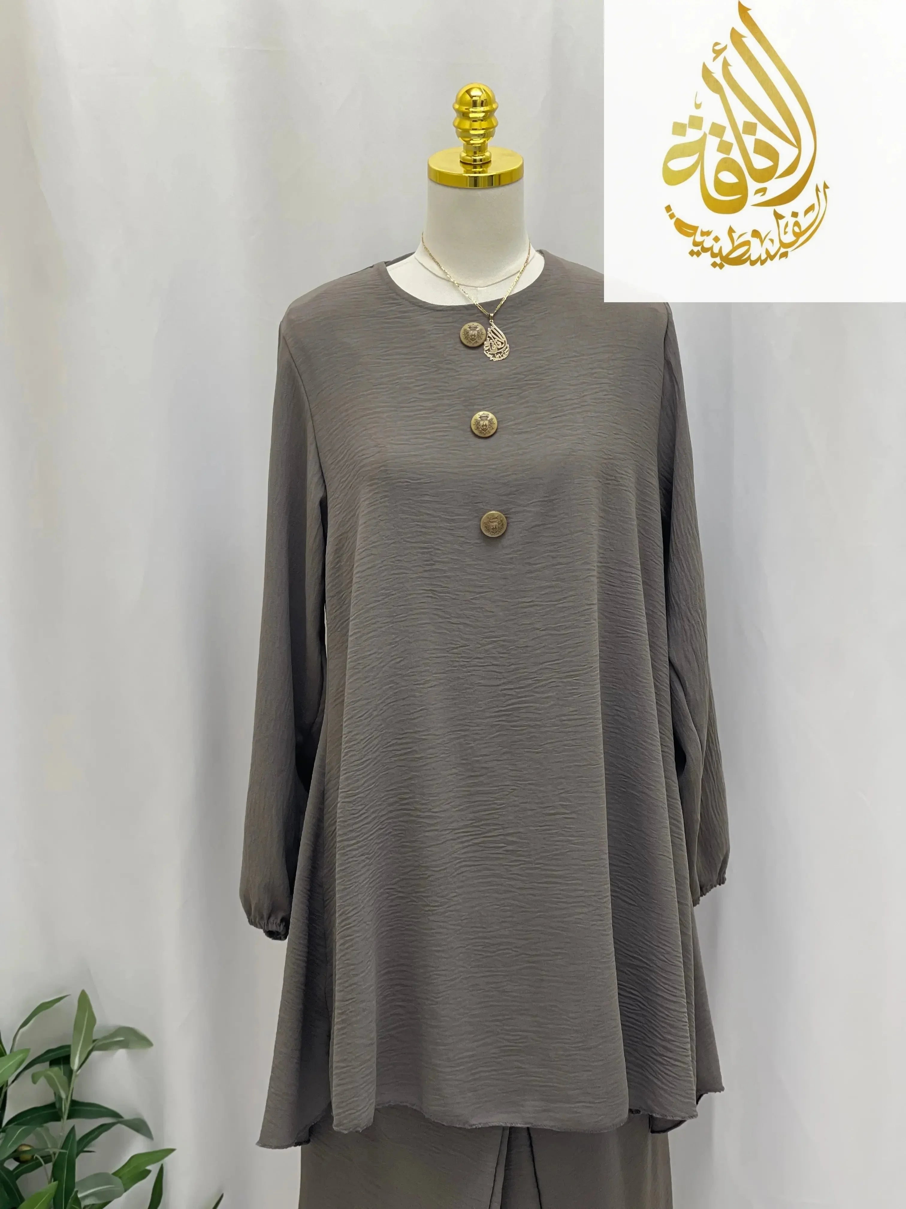 Palestinian Elegance modest long tunic and pant set in muted taupe with button details on mannequin
