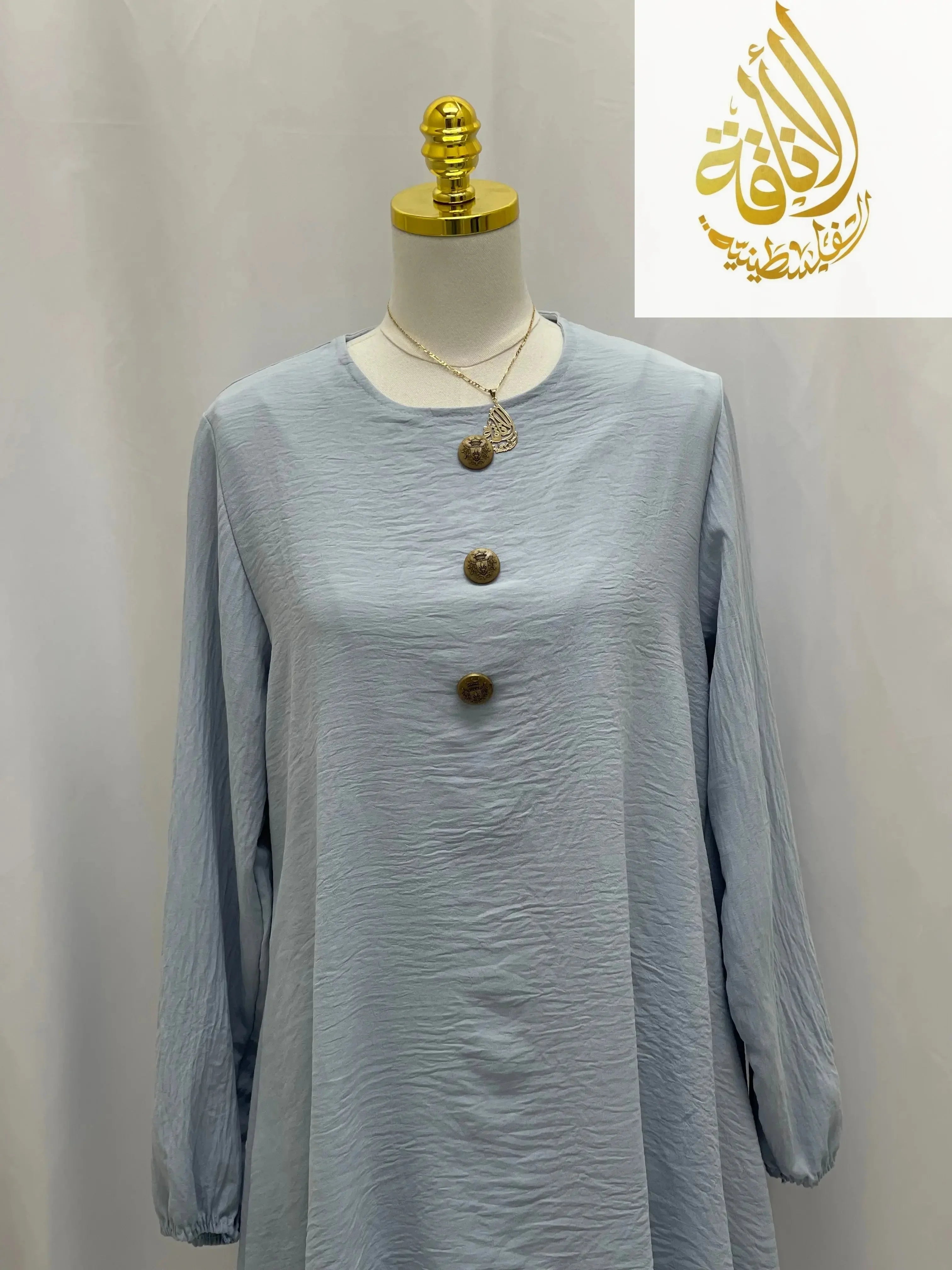 Light blue modest long tunic and pant set from Palestinian Elegance with long sleeves and decorative buttons