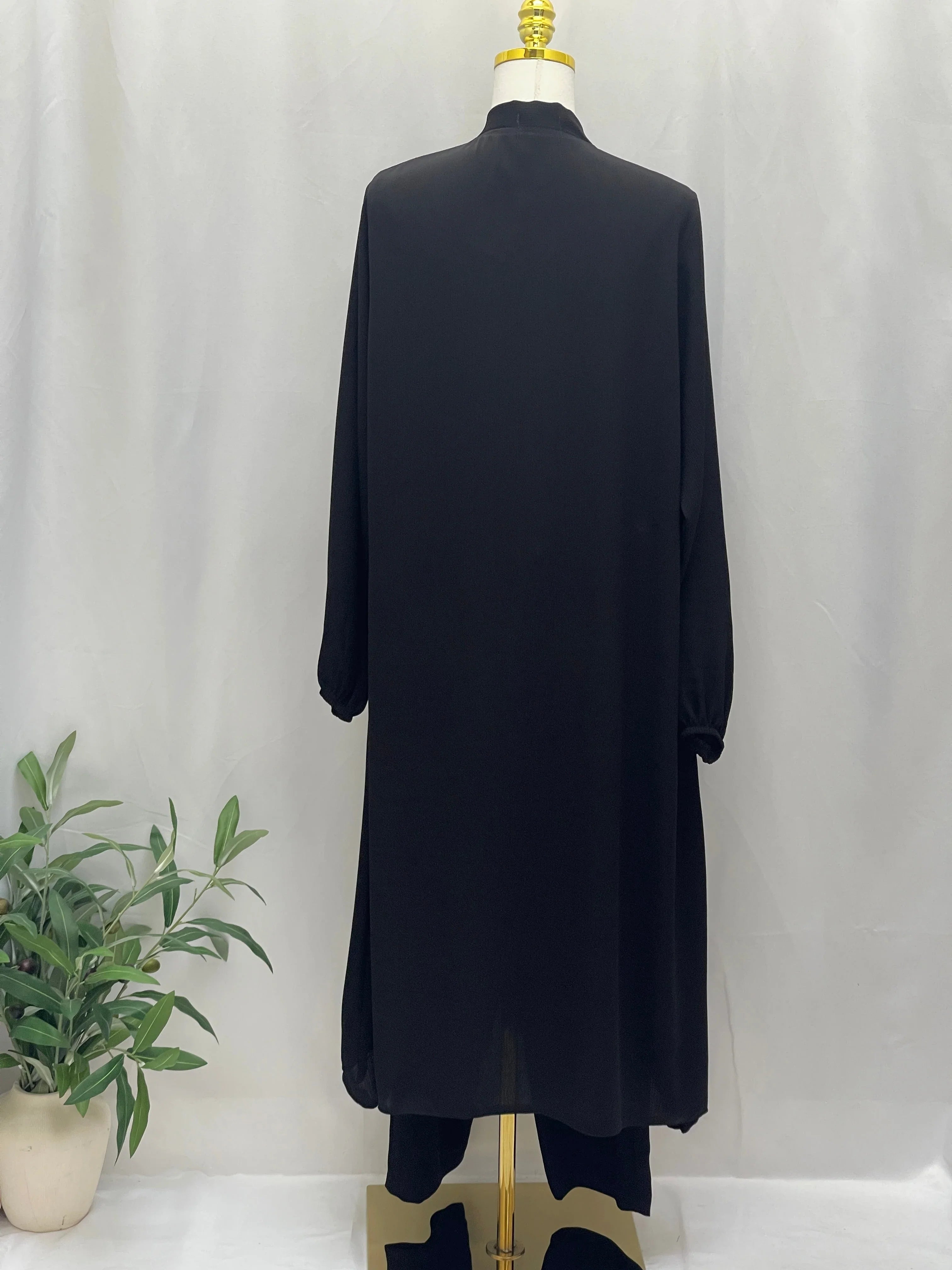 Palestinian Elegance black Modesty Long Set back view high collar long tunic and matching pants on mannequin