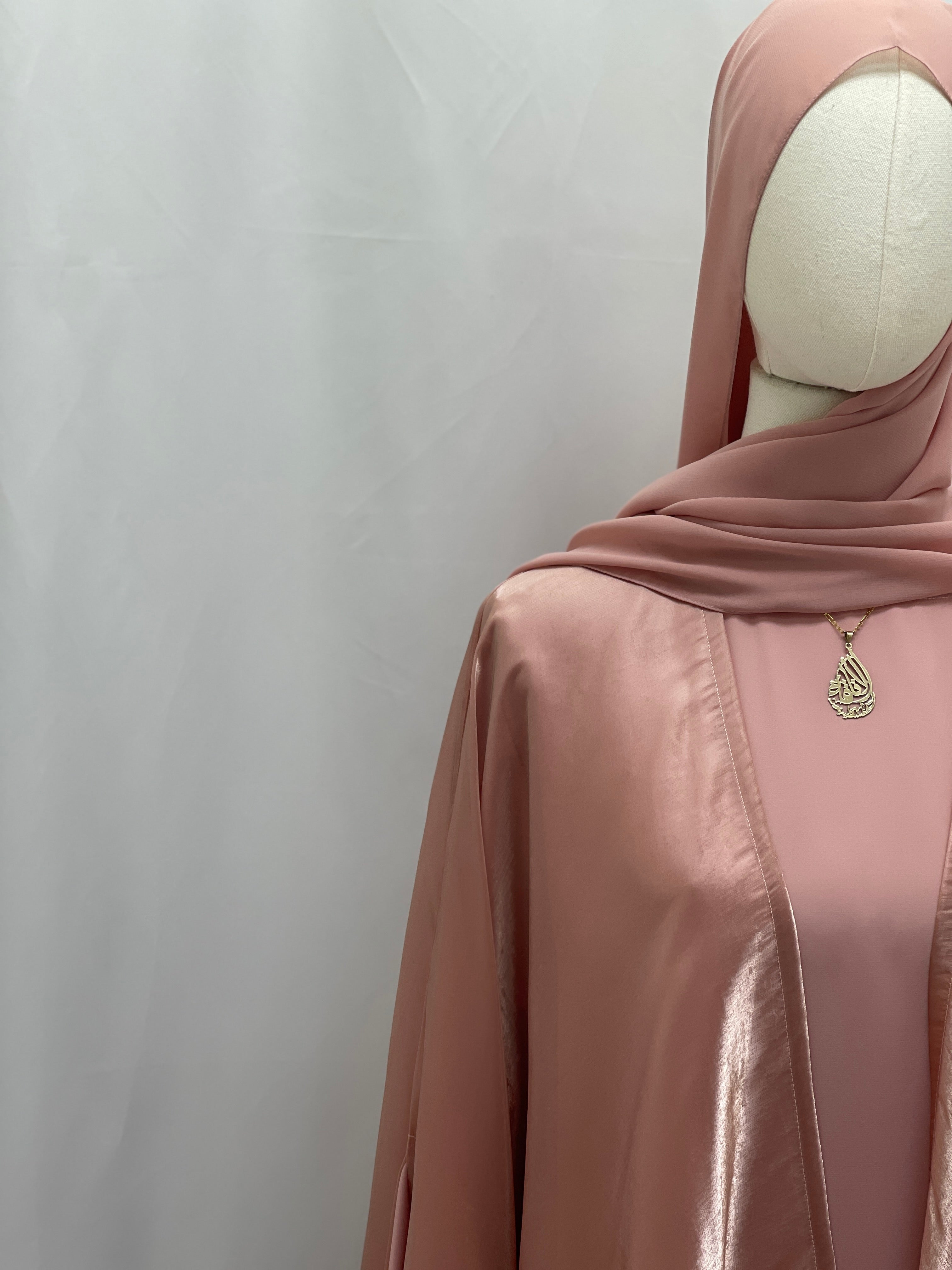 Moonlit Organza Abaya in soft pink satin fabric from Palestinian Elegance on a mannequin