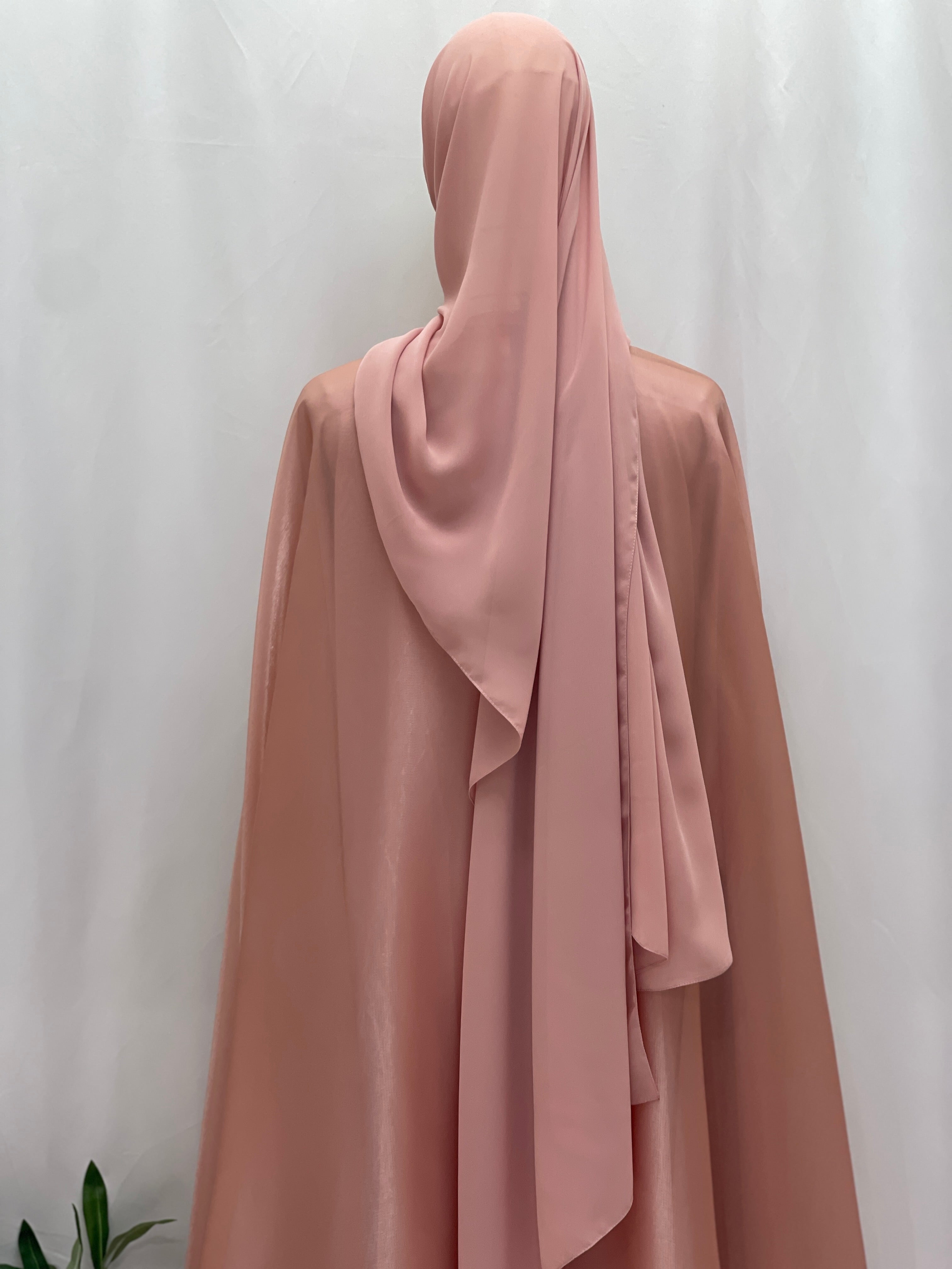 Back view of Palestinian Elegance Moonlit Organza Abaya in soft pink with matching hijab on white background