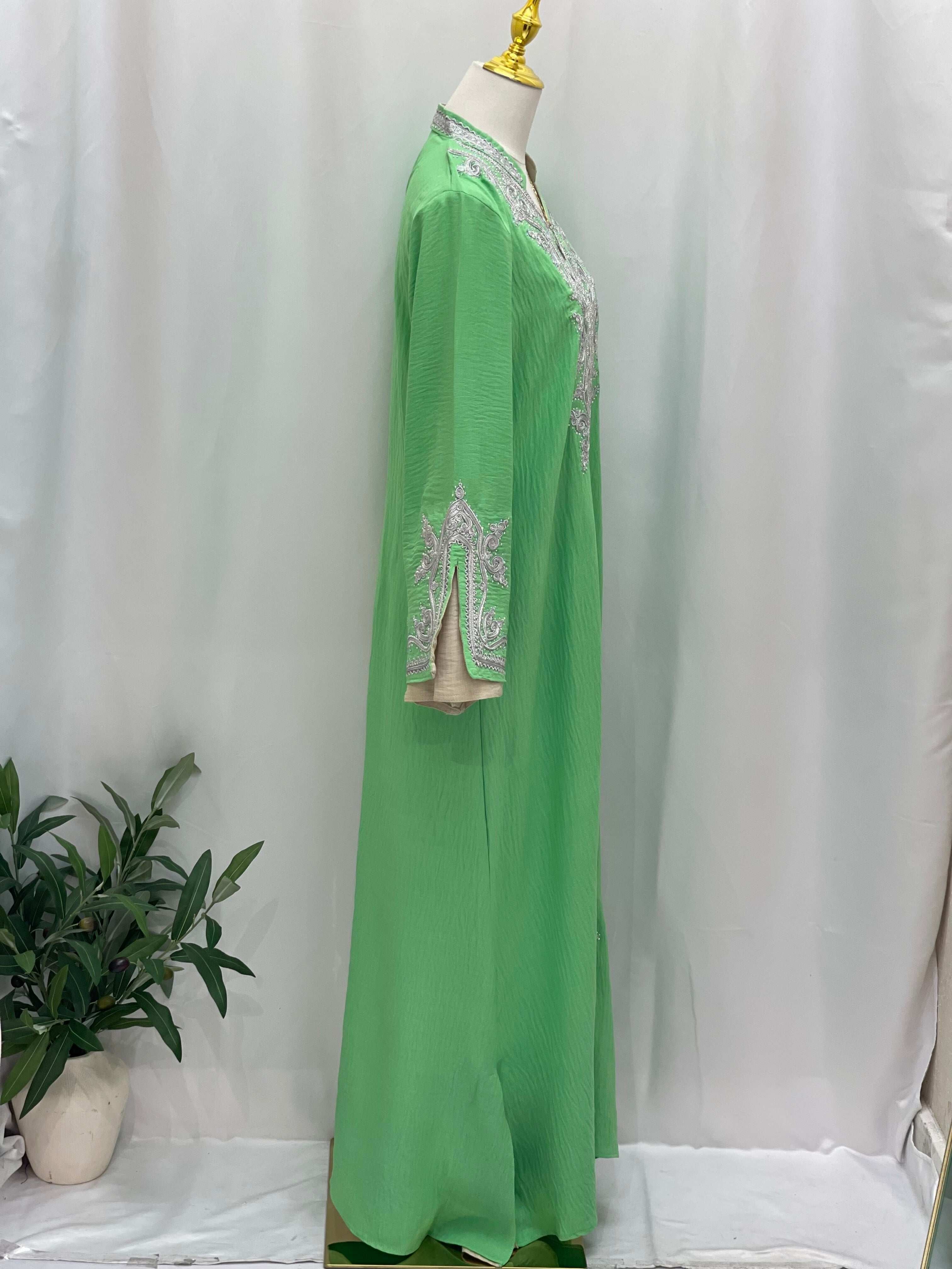 Green Moroccan  Rana Jalabia abaya with white embroidery on sleeves and neckline by Palestinian Elegance