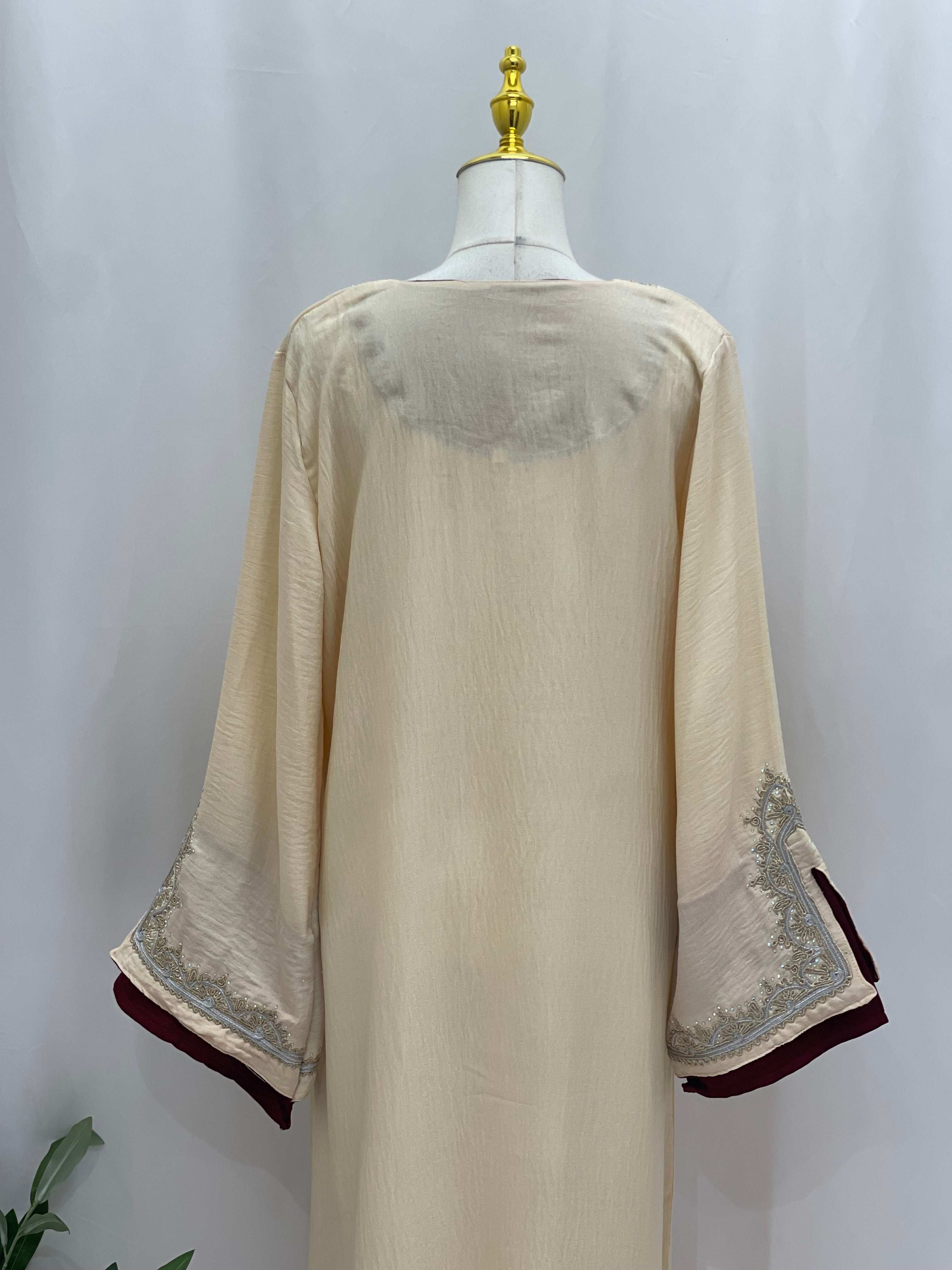 Back view of Palestinian Elegance Moroccan Rana Jalabia abaya in beige with intricate sleeve embroidery