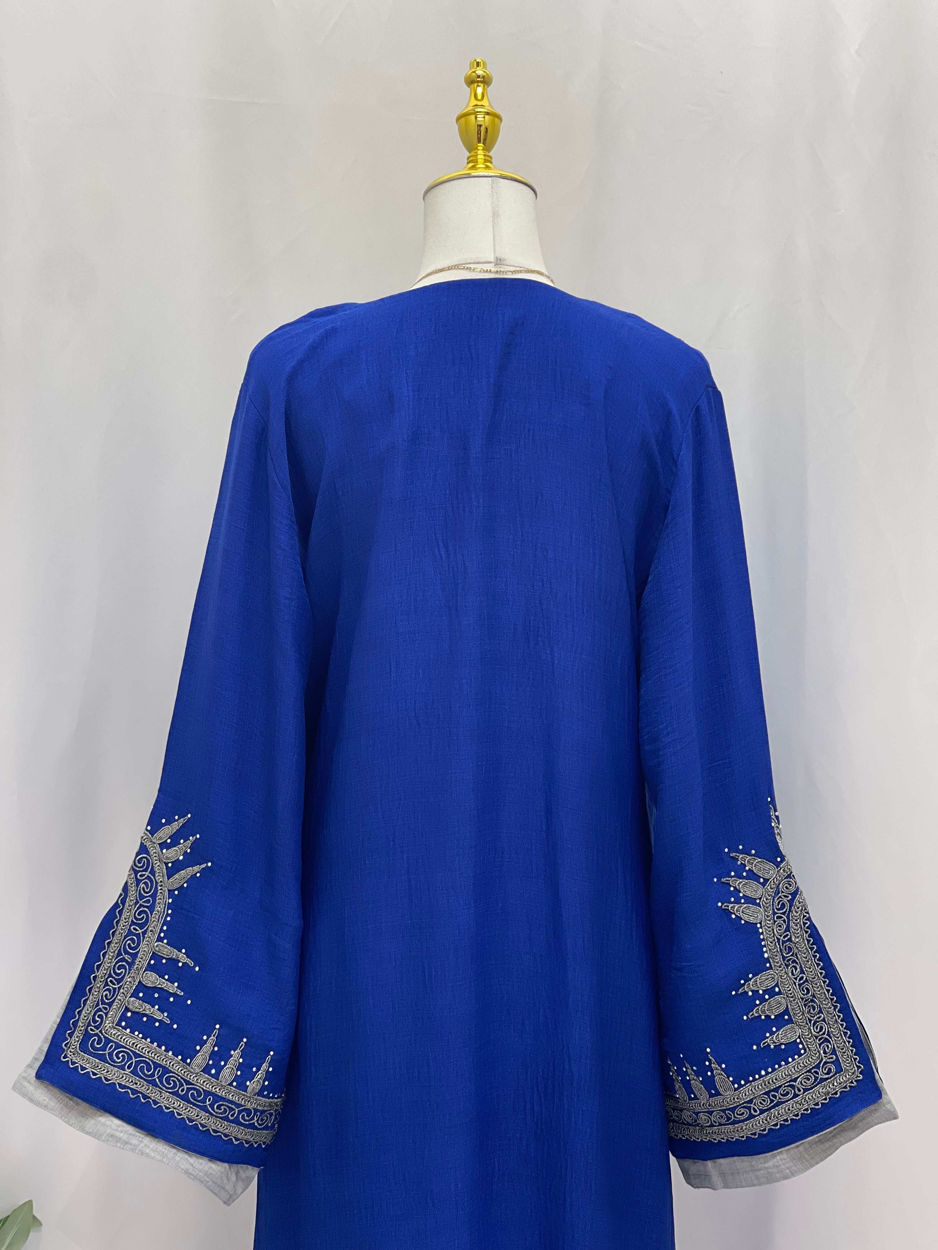 Back view of Moroccan Salma Jalabia abaya in royal blue with intricate silver embroidery on wide sleeves