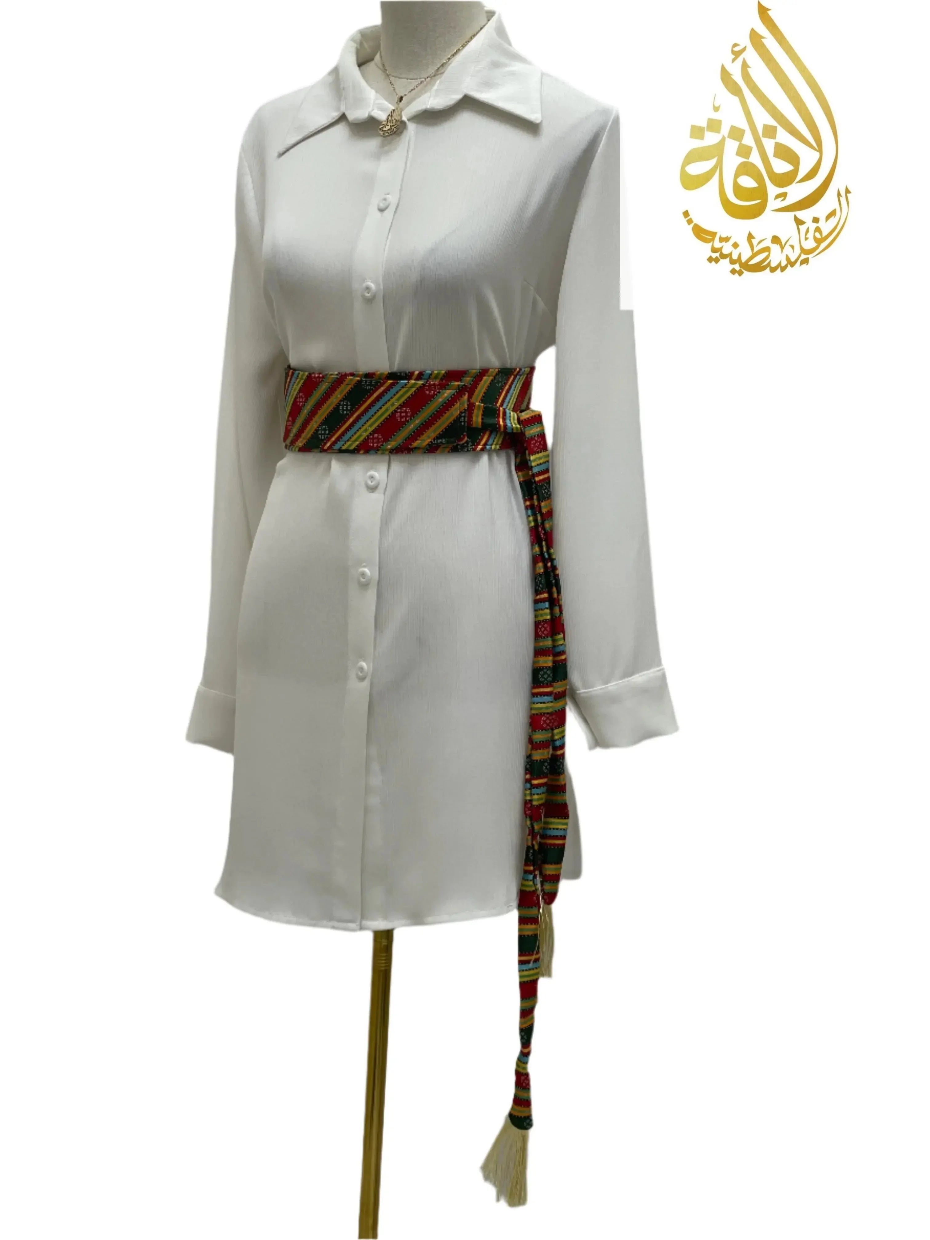 Palestinian embroidered belt with colorful traditional patterns styled over white shirt dress