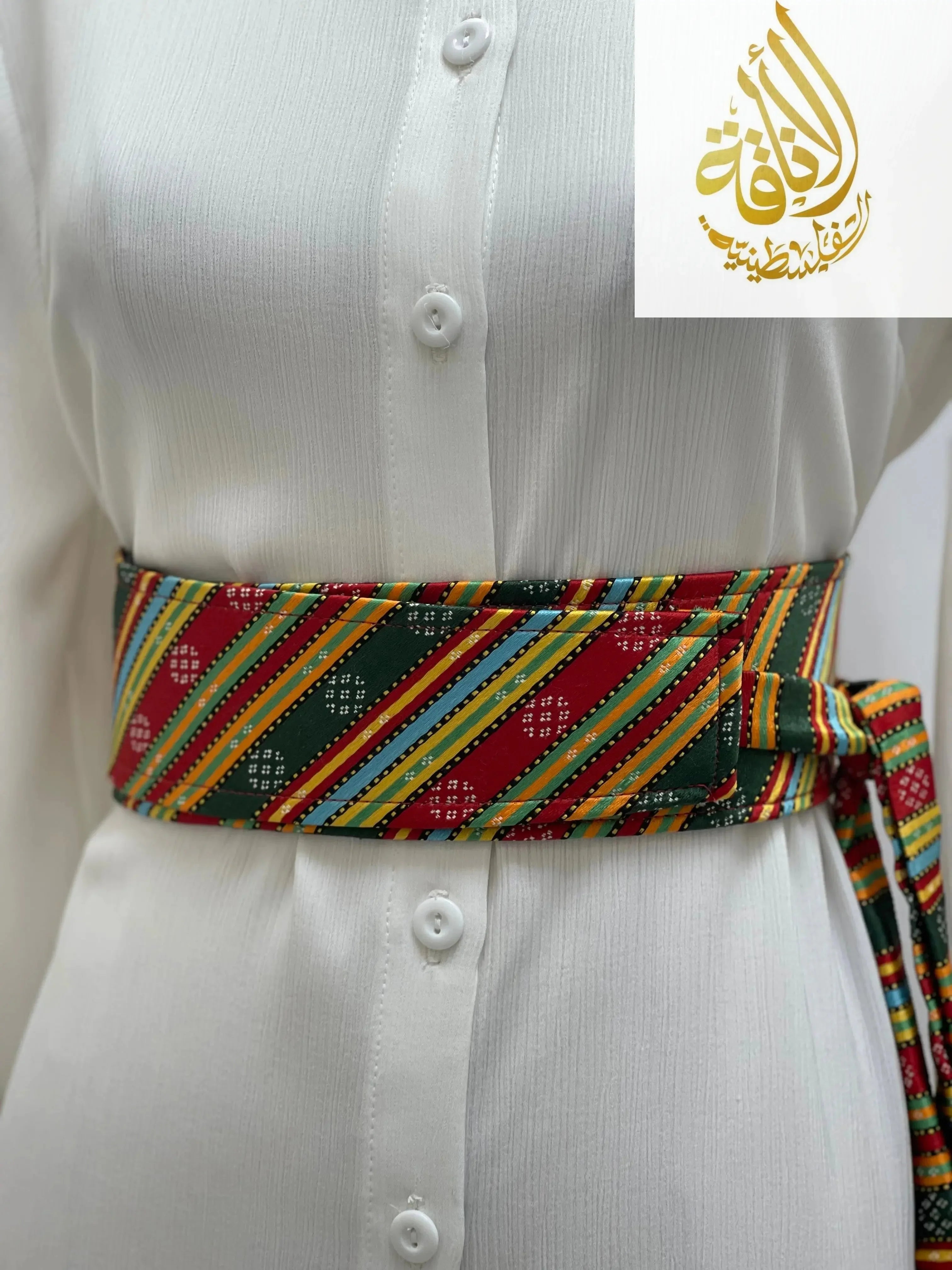 Palestinian embroidered belt with colorful striped traditional patterns worn over white dress