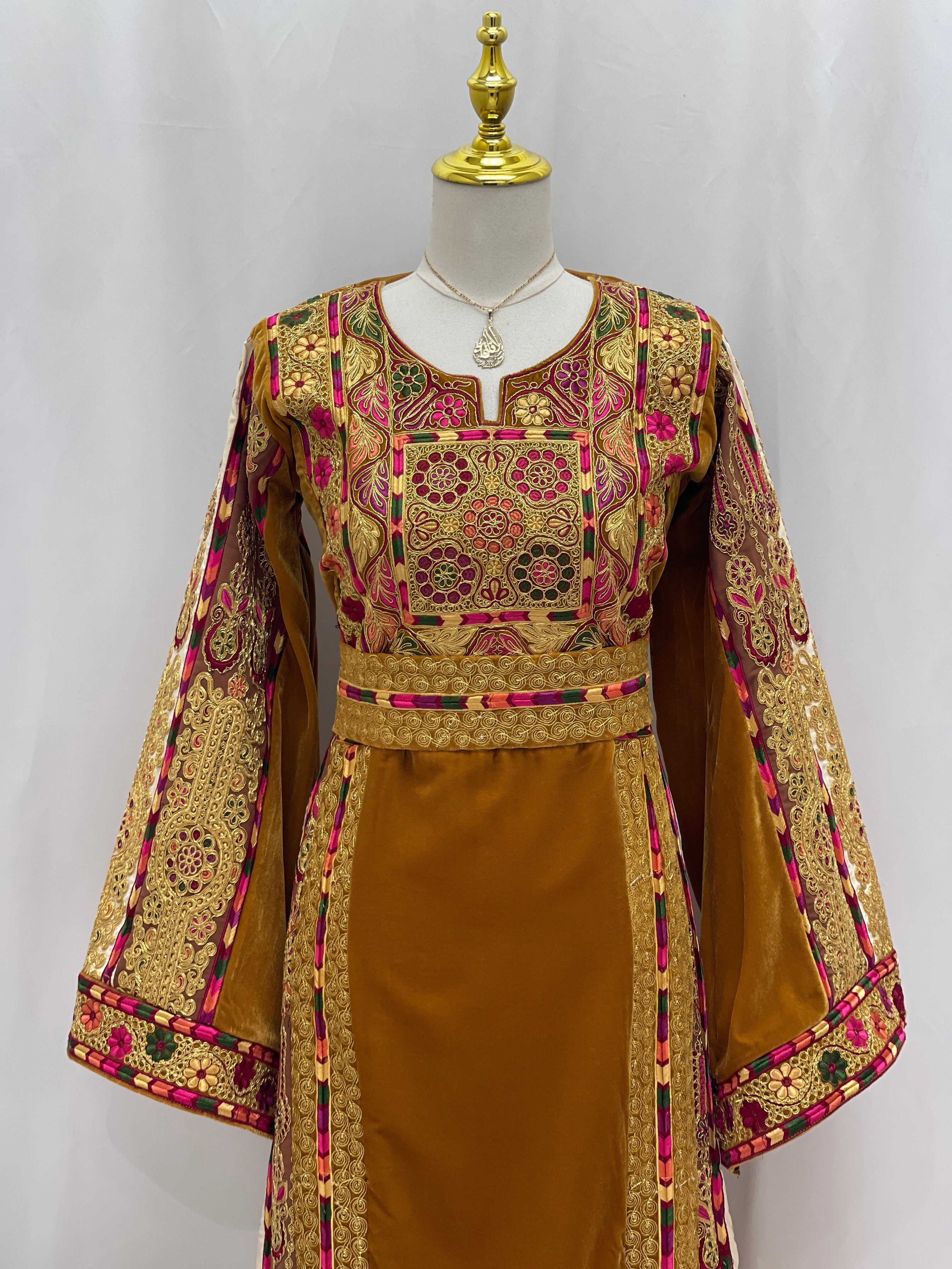 Traditional Malaka Embroidered Thoub in gold with pink and black intricate floral patterns by Palestinian Elegance