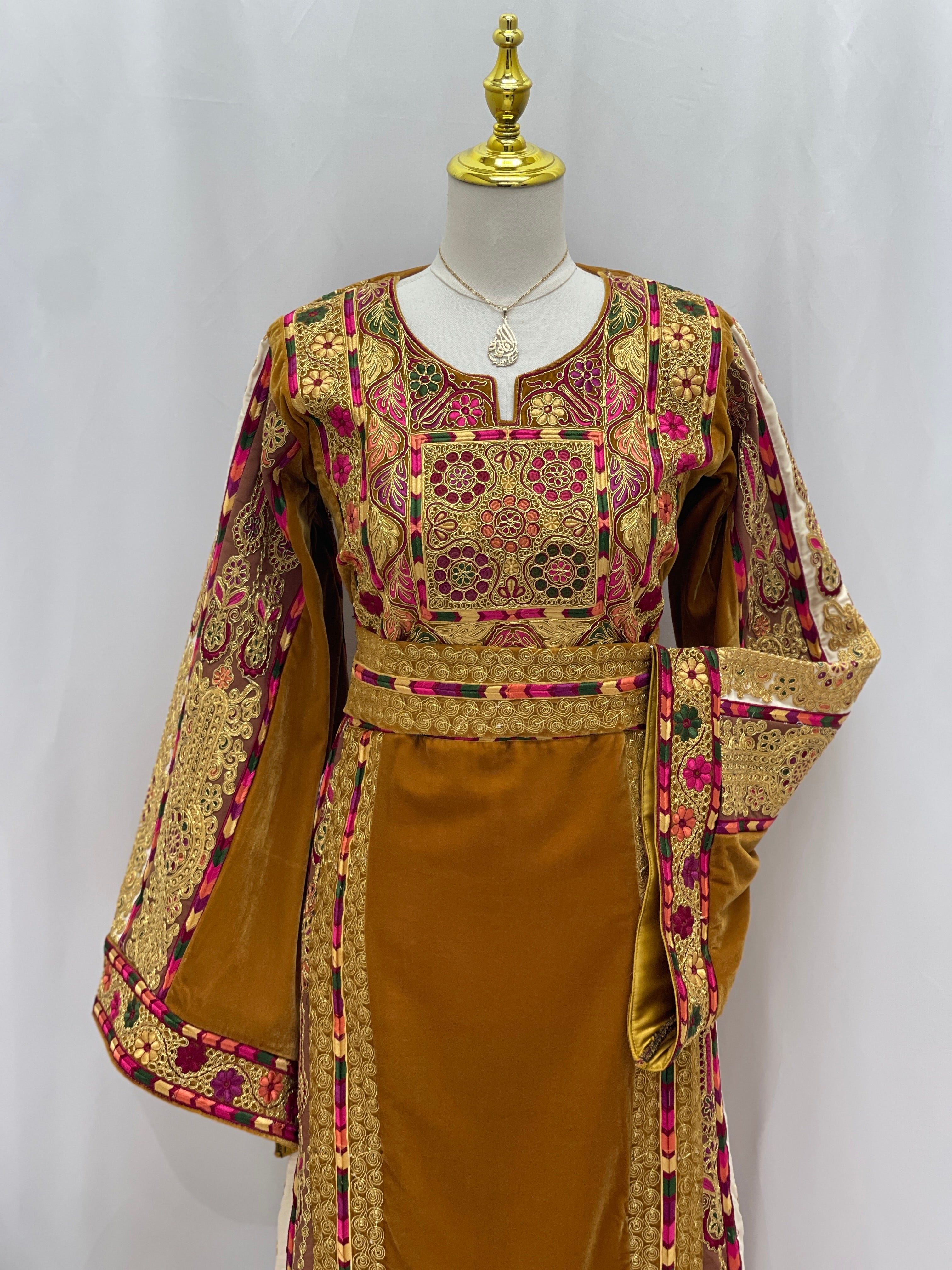 Traditional Malaka Embroidered Thoub by Palestinian Elegance featuring intricate gold and pink embroidery on a mustard fabric