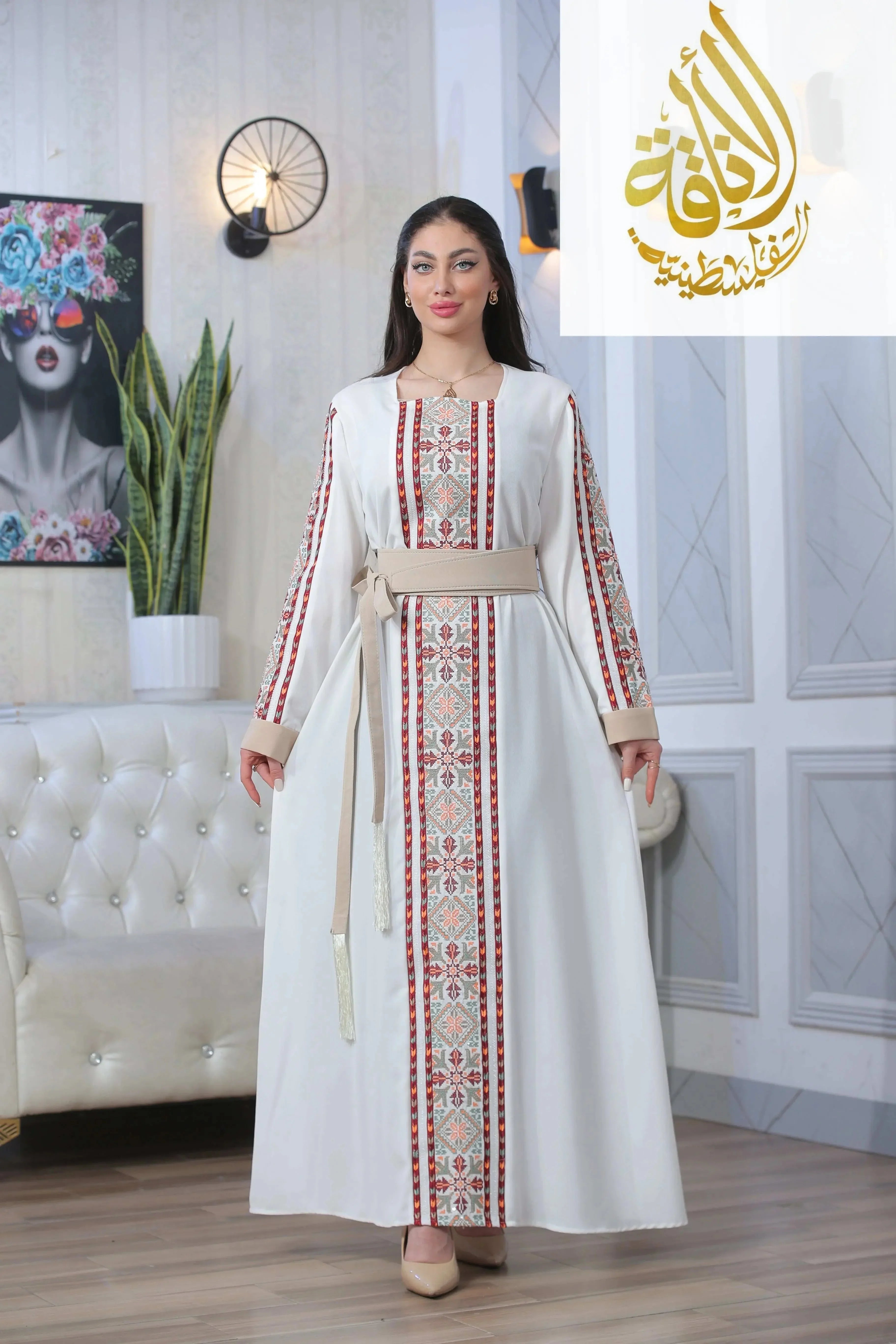 Nadera Embroidered Thoub by Palestinian Elegance featuring traditional intricate embroidery on white fabric with a beige belt