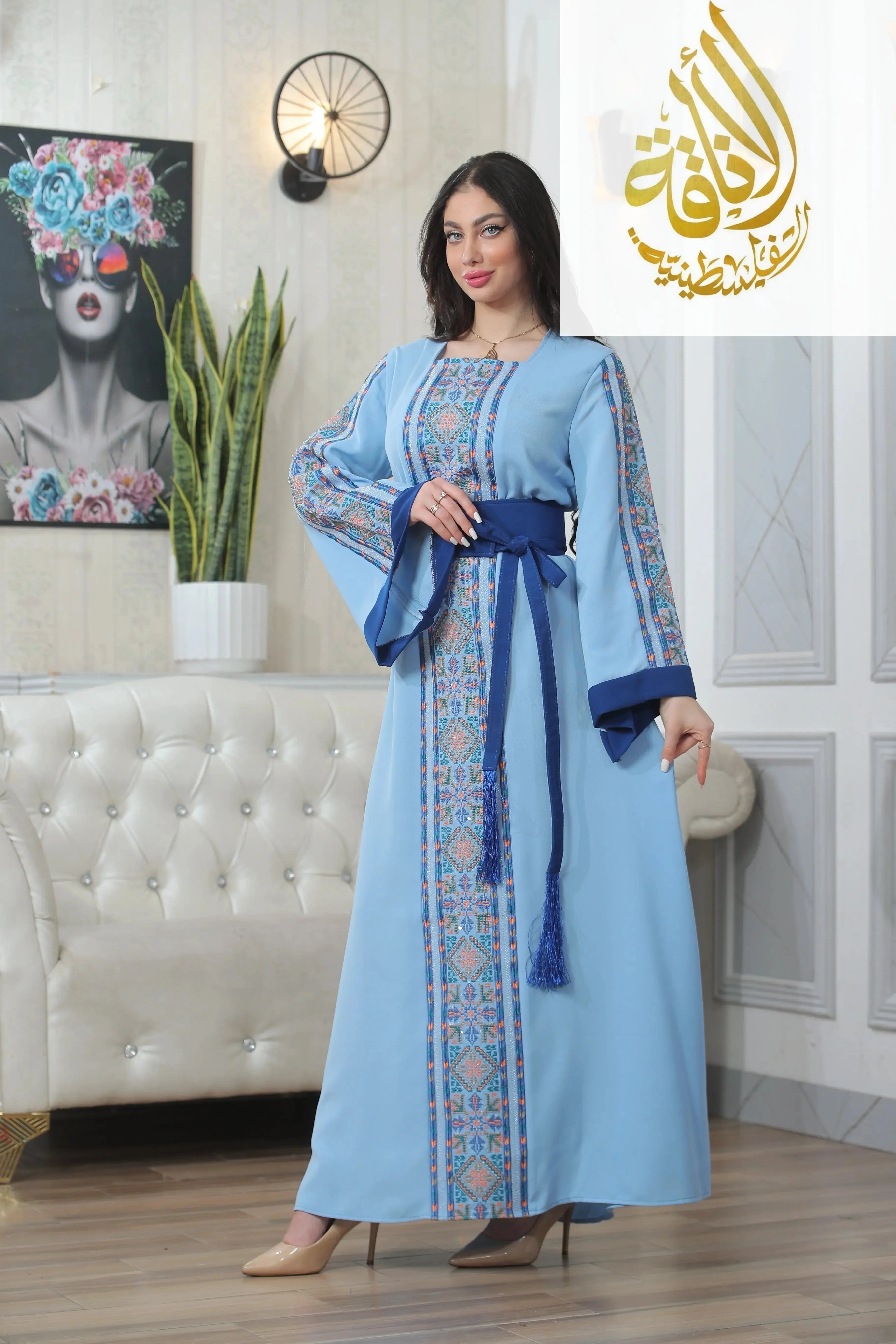 Woman wearing blue Nadera Embroidered Thoub with intricate traditional patterns and navy belt