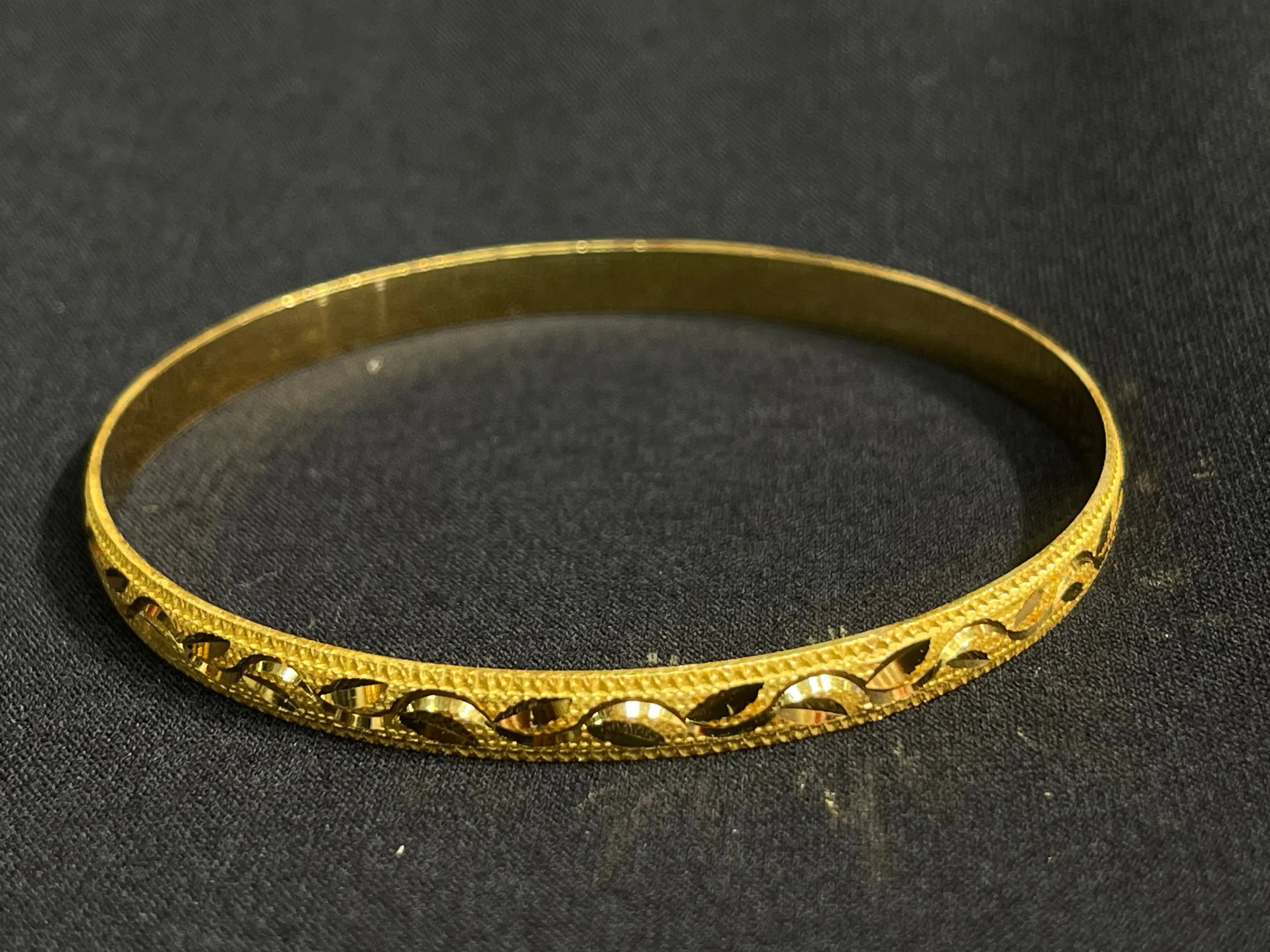 Najwa Bangles with imitated gold design by Palestinian Elegance featuring intricate patterns on a gold-tone bracelet