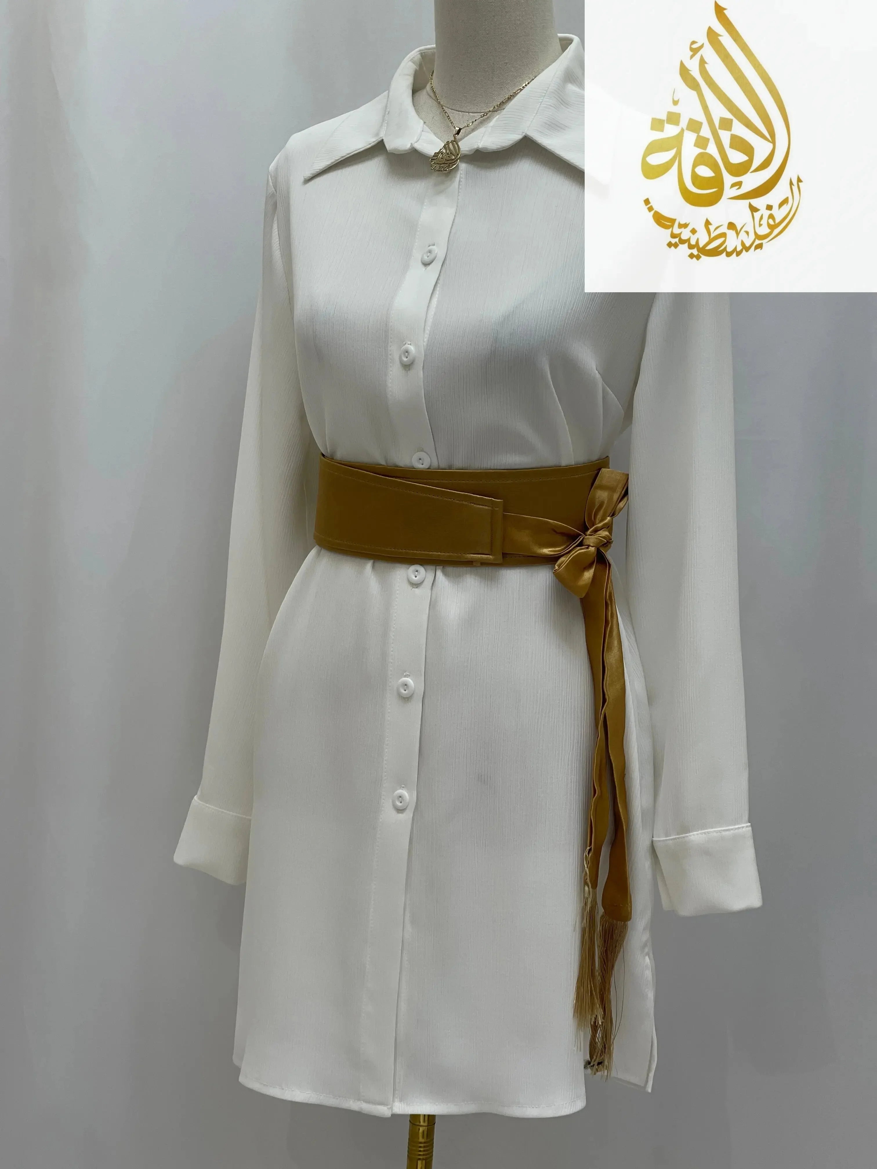 Palestinian Elegance satin belt for dresses in gold wrapped around white button-up shirt dress