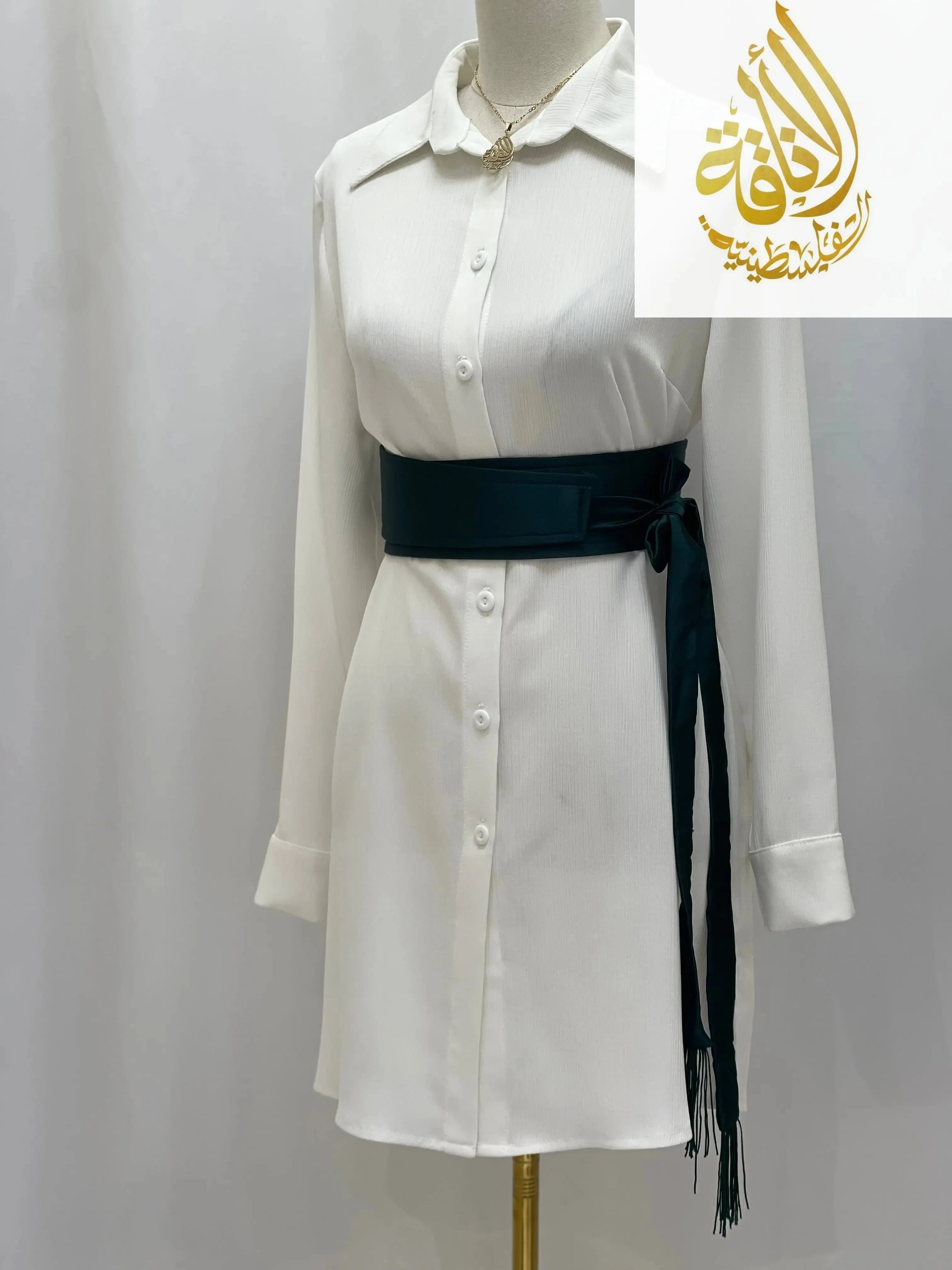 Palestinian Elegance black satin belt for dresses styled on white button down dress with long sleeves