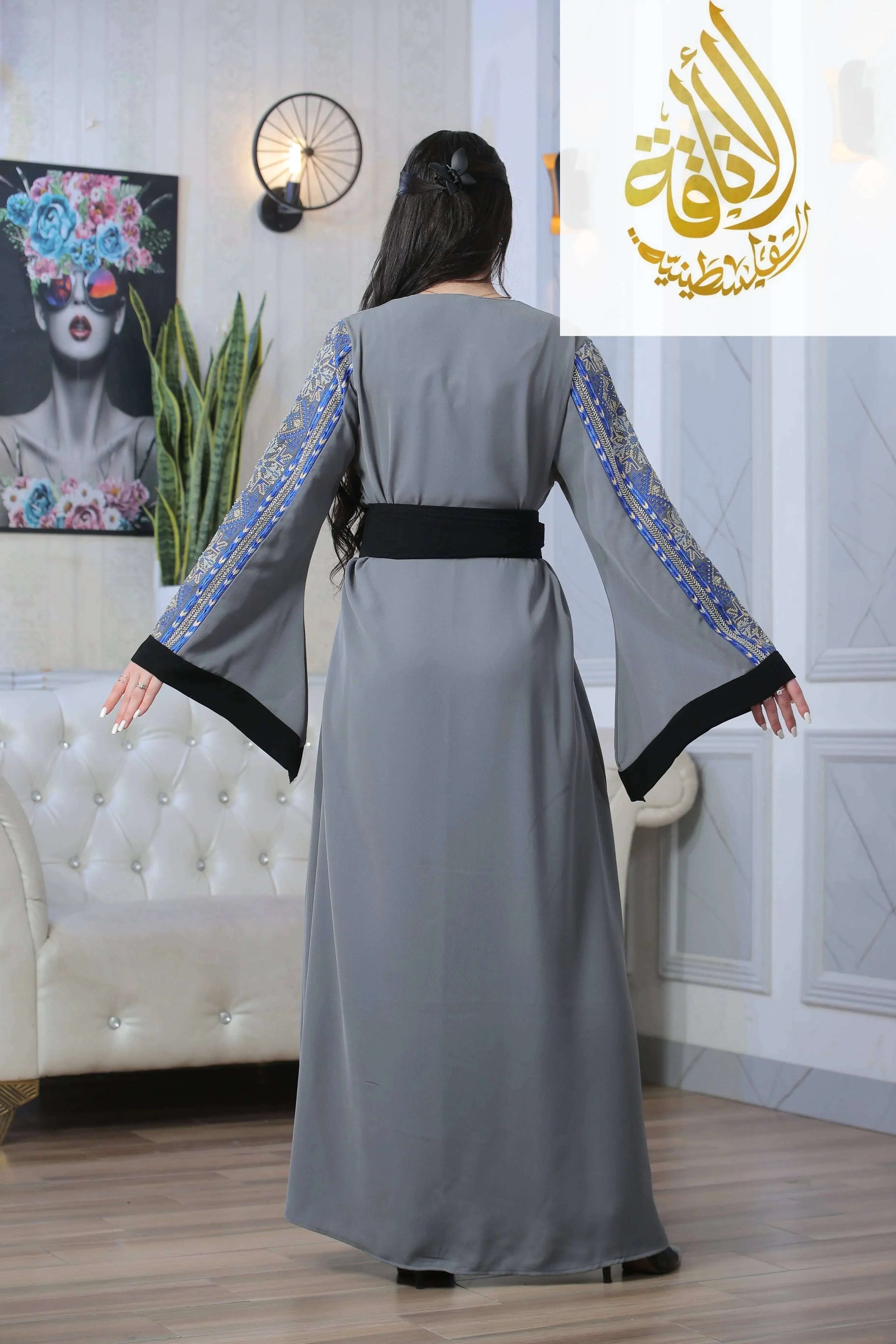 Back view of Moroccan Rana Jalabia Thoub by Palestinian Elegance in gray with blue embroidered sleeves and black belt