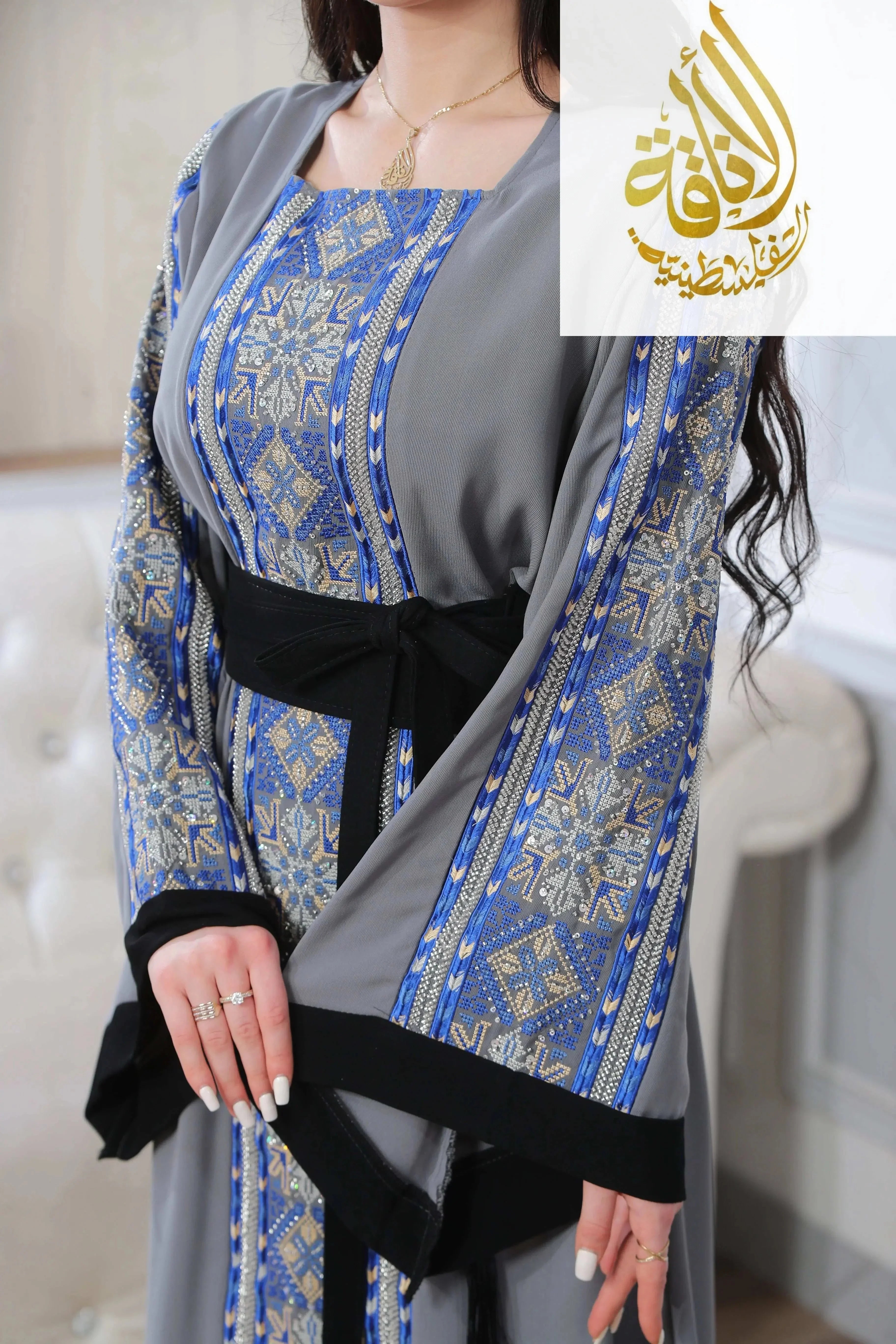 Palestinian Elegance Moroccan Rana Jalabia Thoub with intricate blue and gold geometric patterns and black waist belt