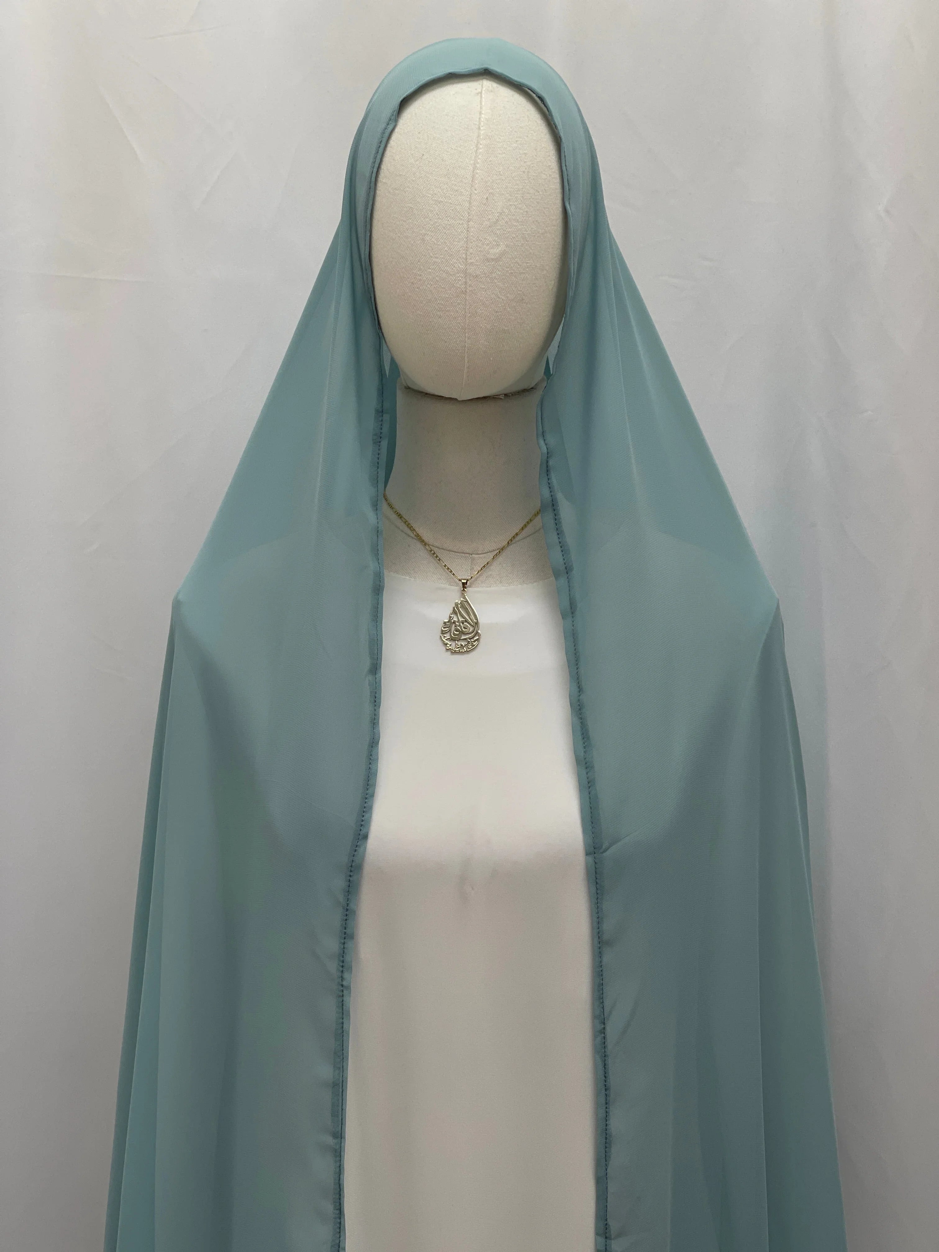 New Khirka With White tassel by Palestinian Elegance light blue chiffon khirka on mannequin with gold pendant