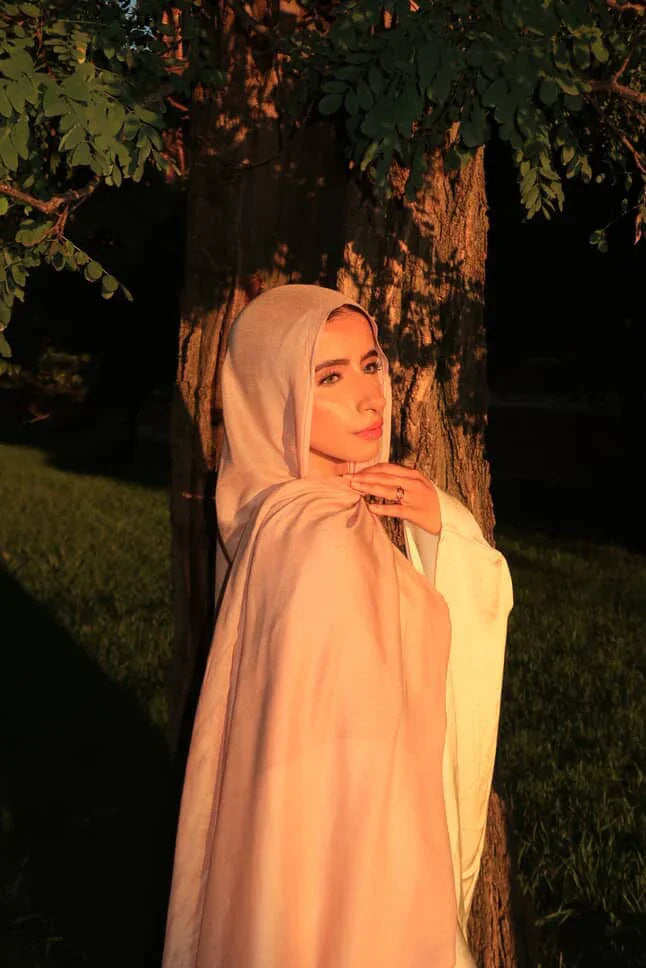 Palestinian Elegance New Modal Hijab pale blush pink draped on woman by tree in warm sunset light