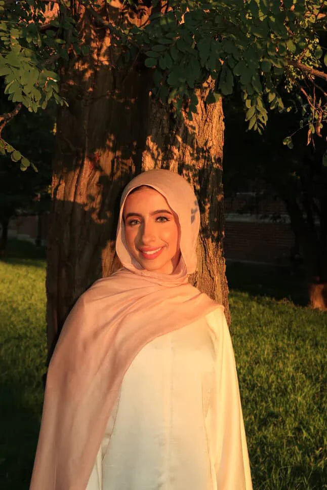 Palestinian Elegance New Modal Hijab in soft blush pink worn by smiling woman in sunset light