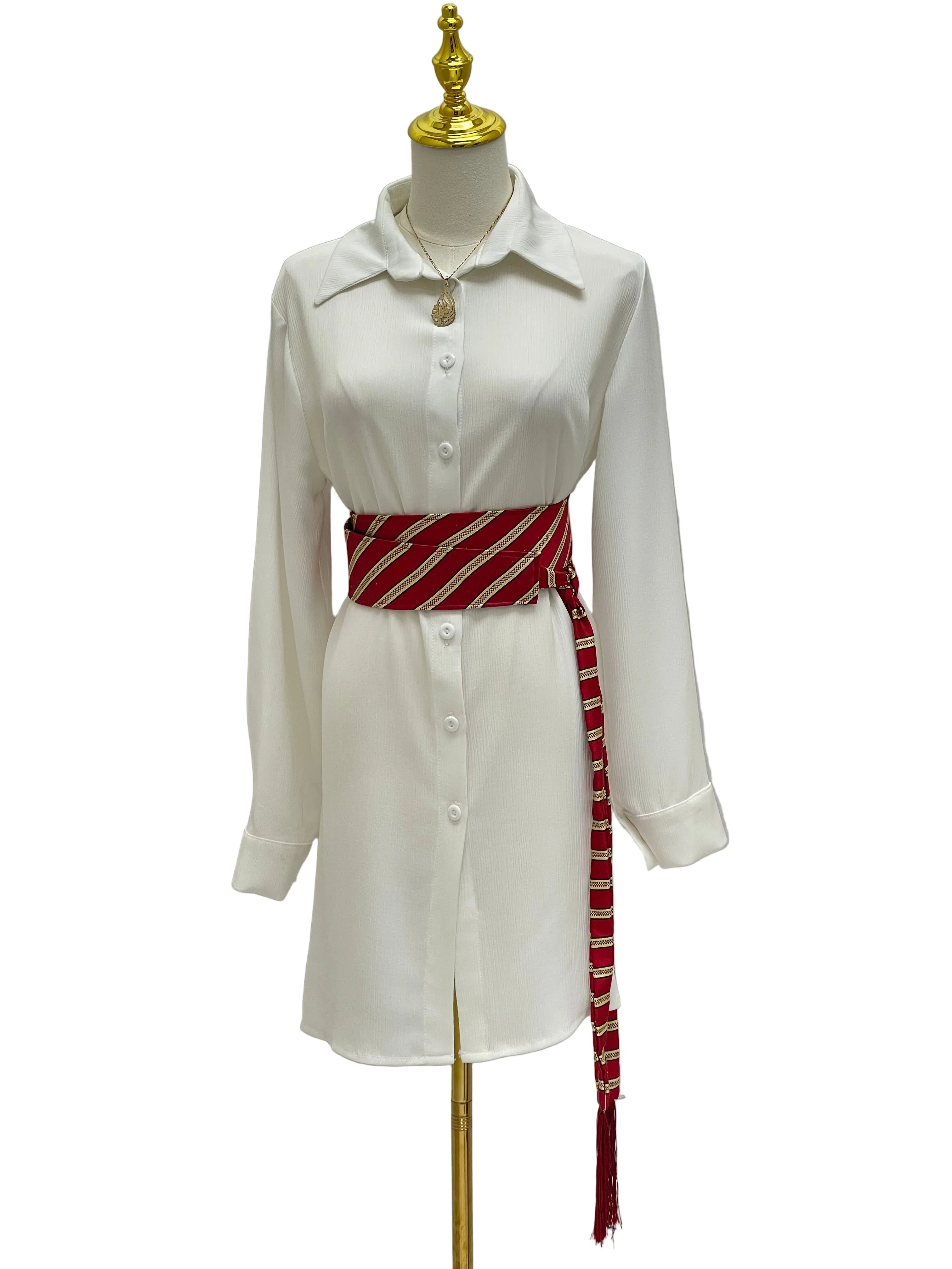 Palestinian Elegance Saya Belt red striped woven obi style belt tied over white shirt dress with tassel