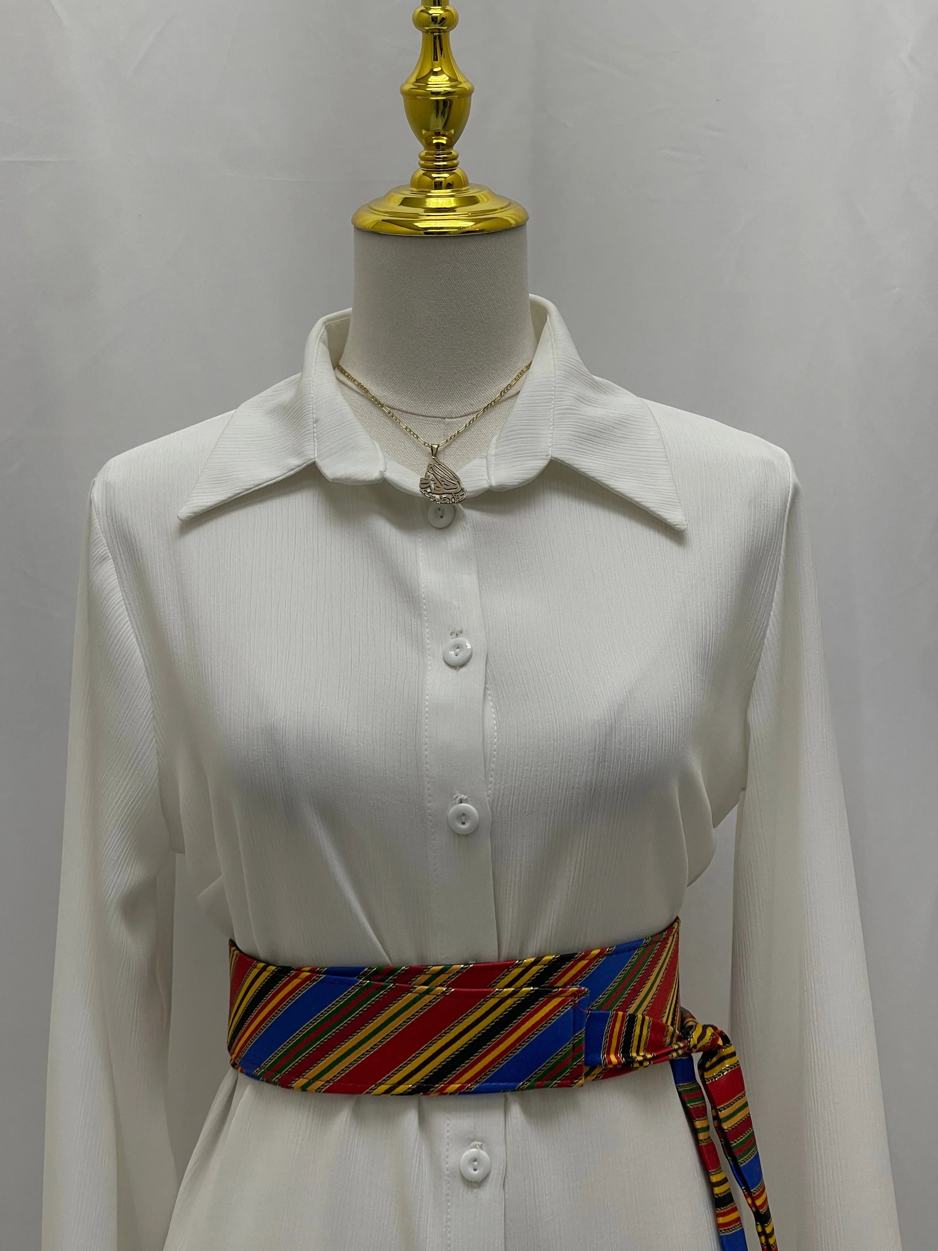 Saya Belt colorful striped waist sash by Palestinian Elegance on white button up dress on mannequin