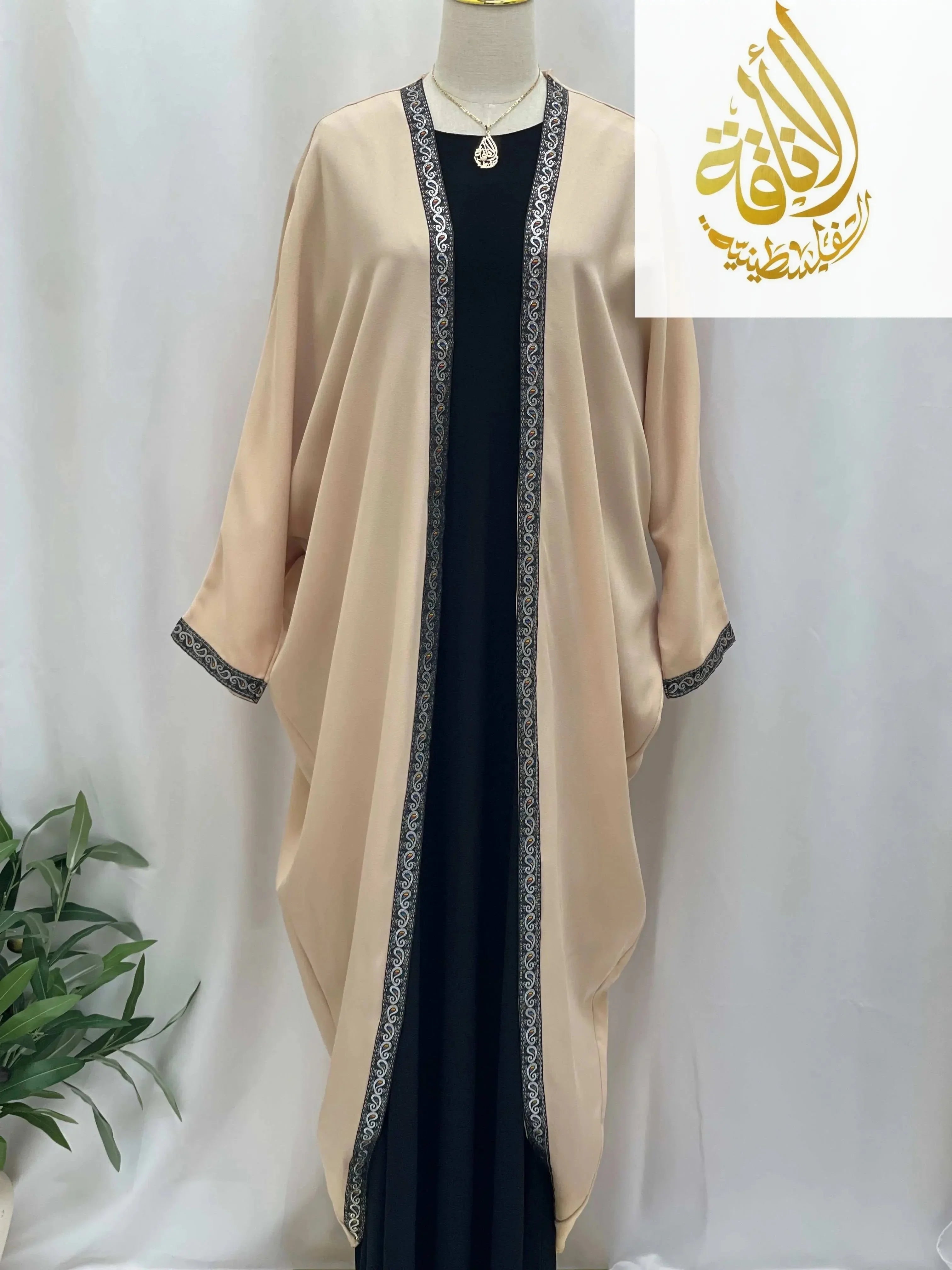 Palestinian Elegance Nijma Free Size kimono beige cardigan with black embroidered trim over black dress