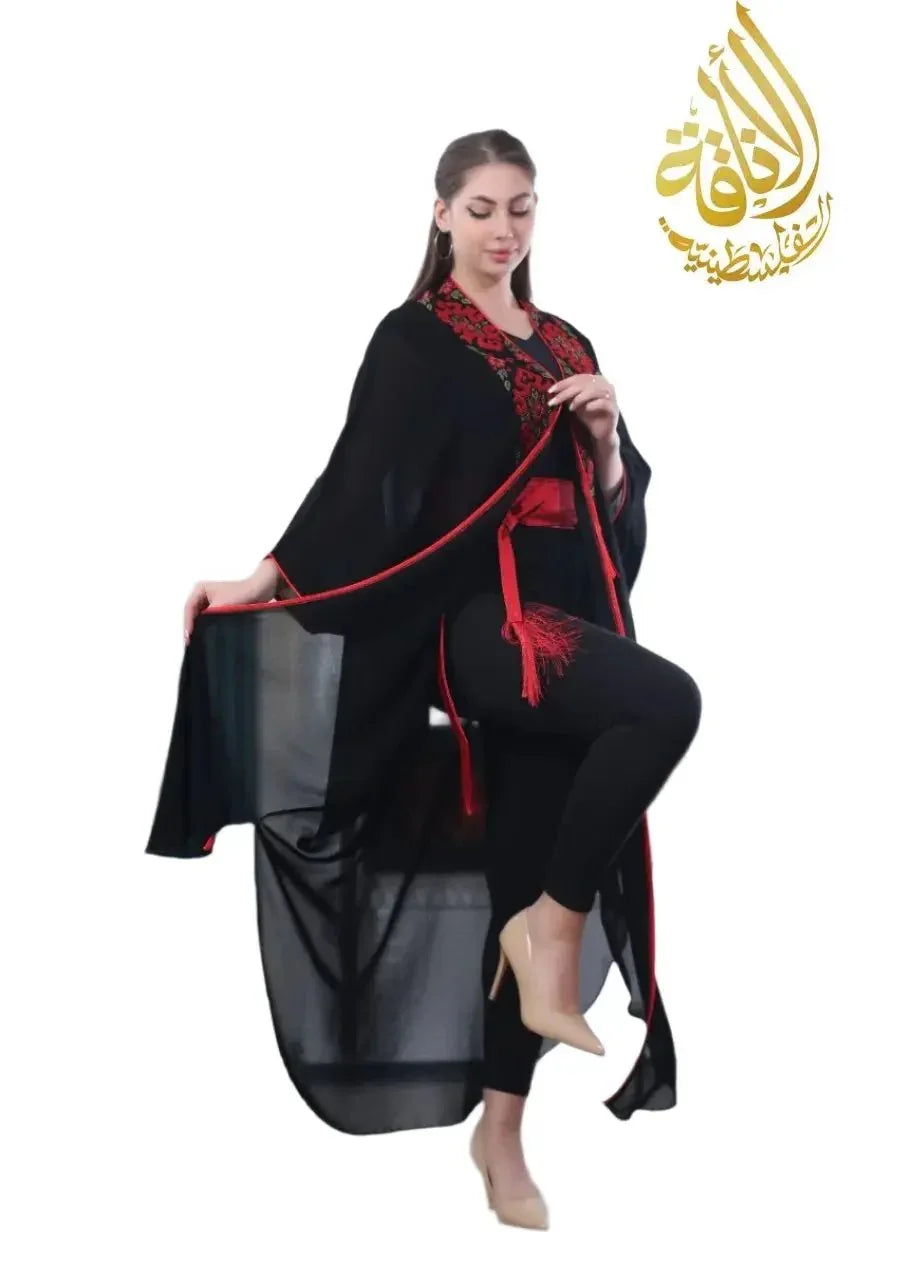 Black embroidered bisht for women with red floral embroidery and tassel belt by Palestinian Elegance