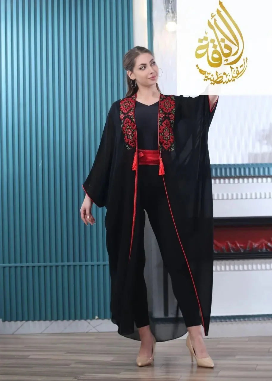 Black embroidered bisht for women with red floral embroidery and sash by Palestinian Elegance