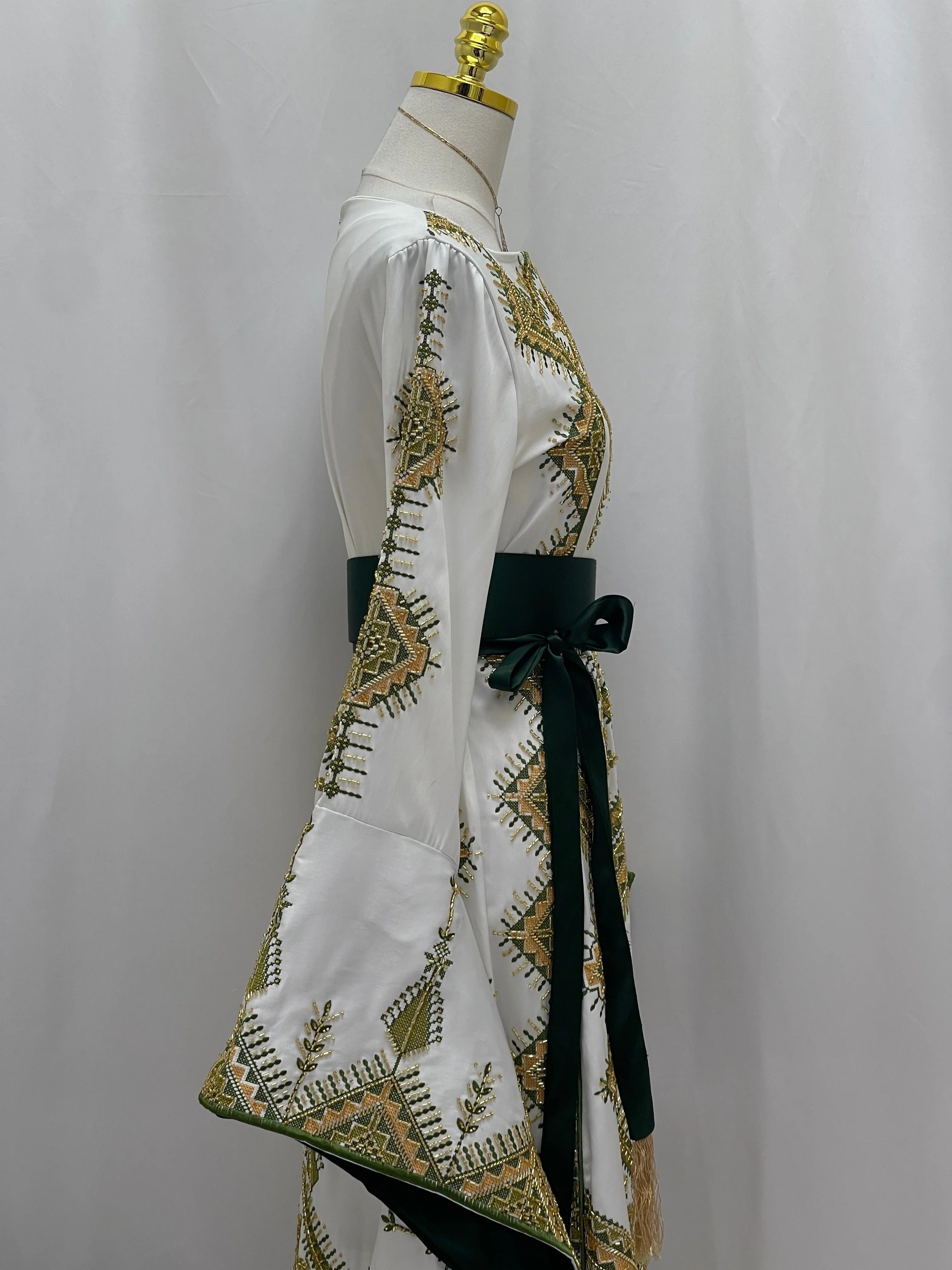 Palestinian Elegance Olive Bloom Bridal Embroidered Dress white gown with olive gold Palestinian embroidery and dark green sash
