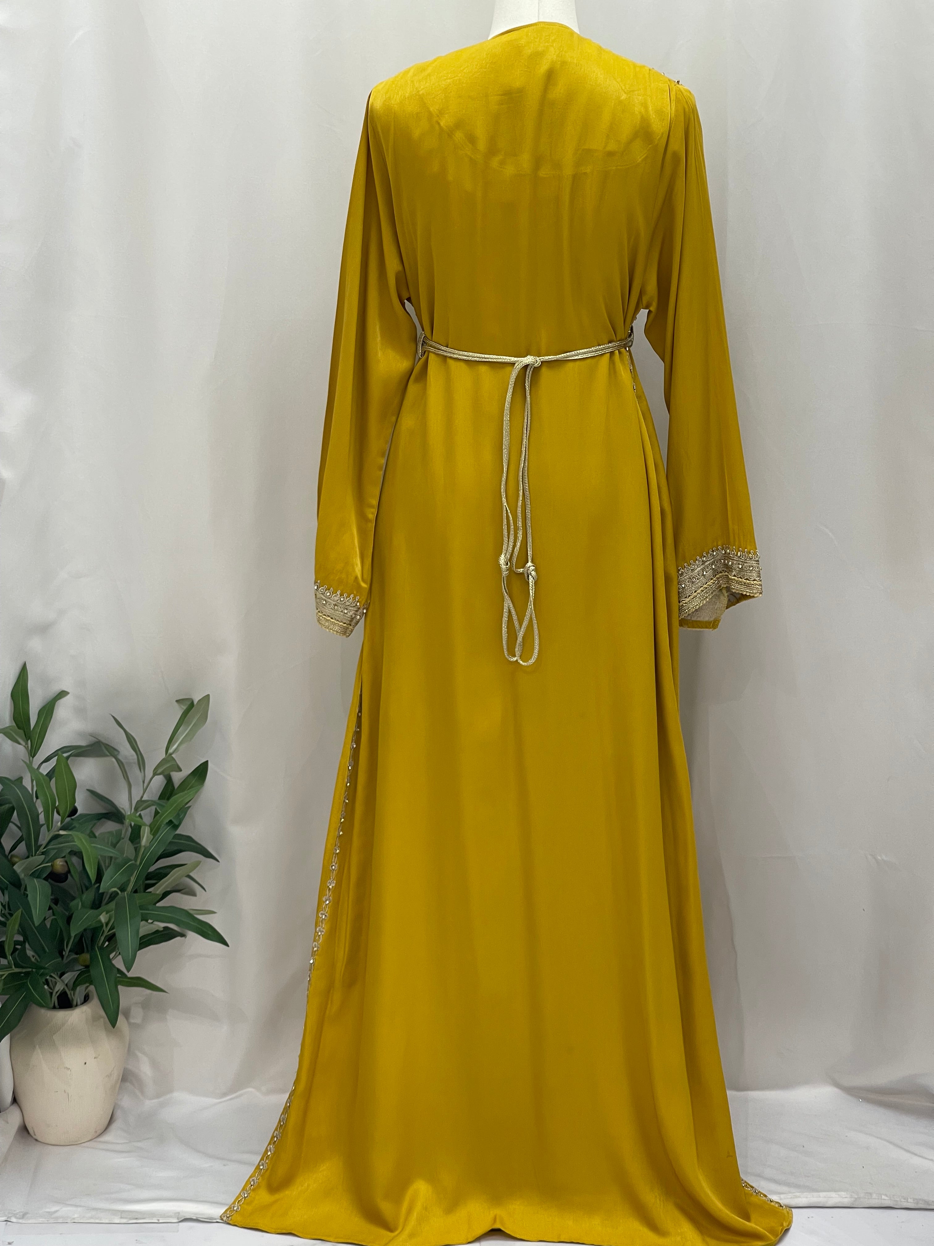 Back view of Omima Morocco Style Kaftan by Palestinian Elegance in mustard yellow with detailed sleeves and waist tie