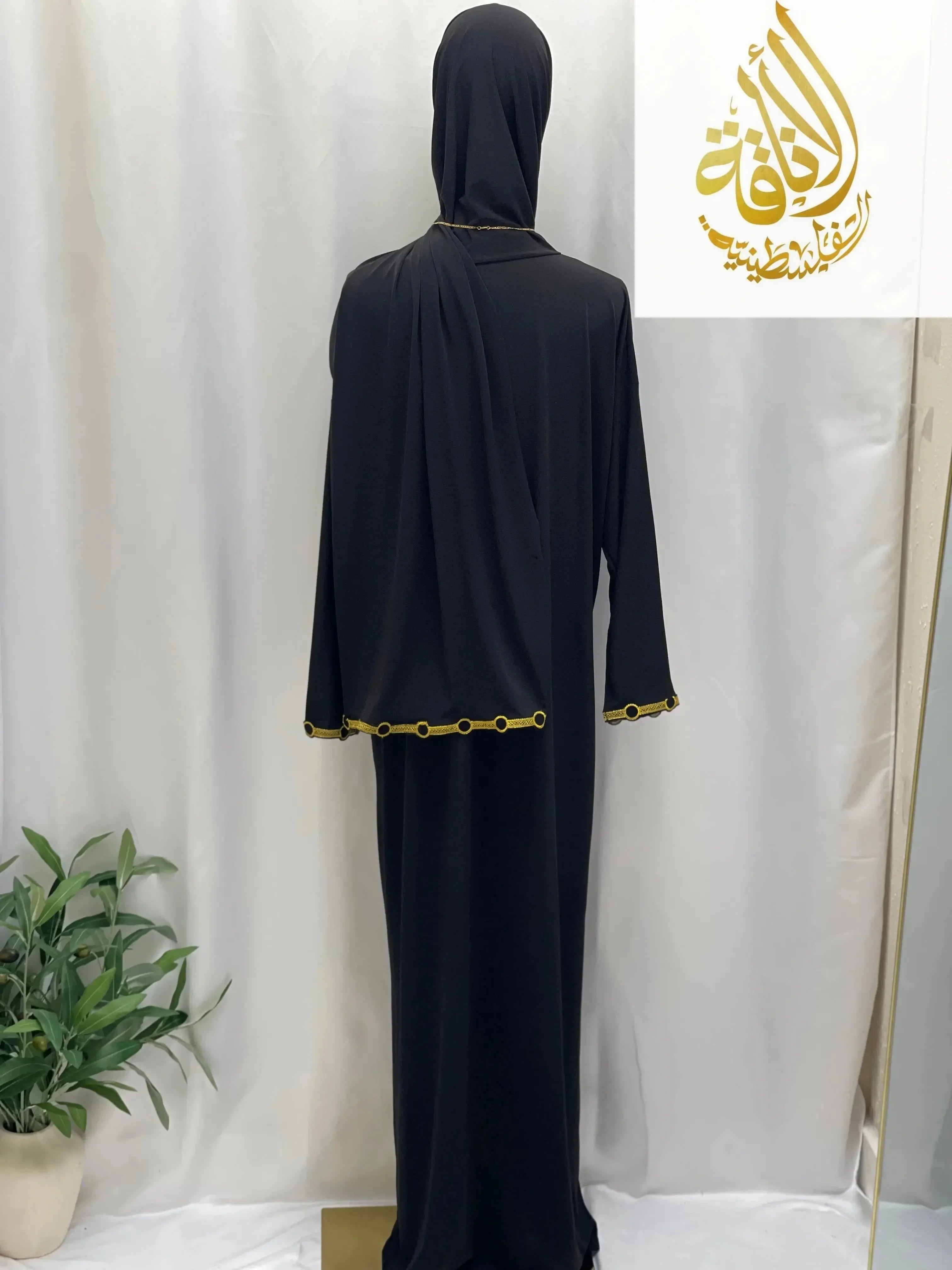 Palestinian Elegance black comfortable one piece prayer dress with gold trim on sleeves and hem