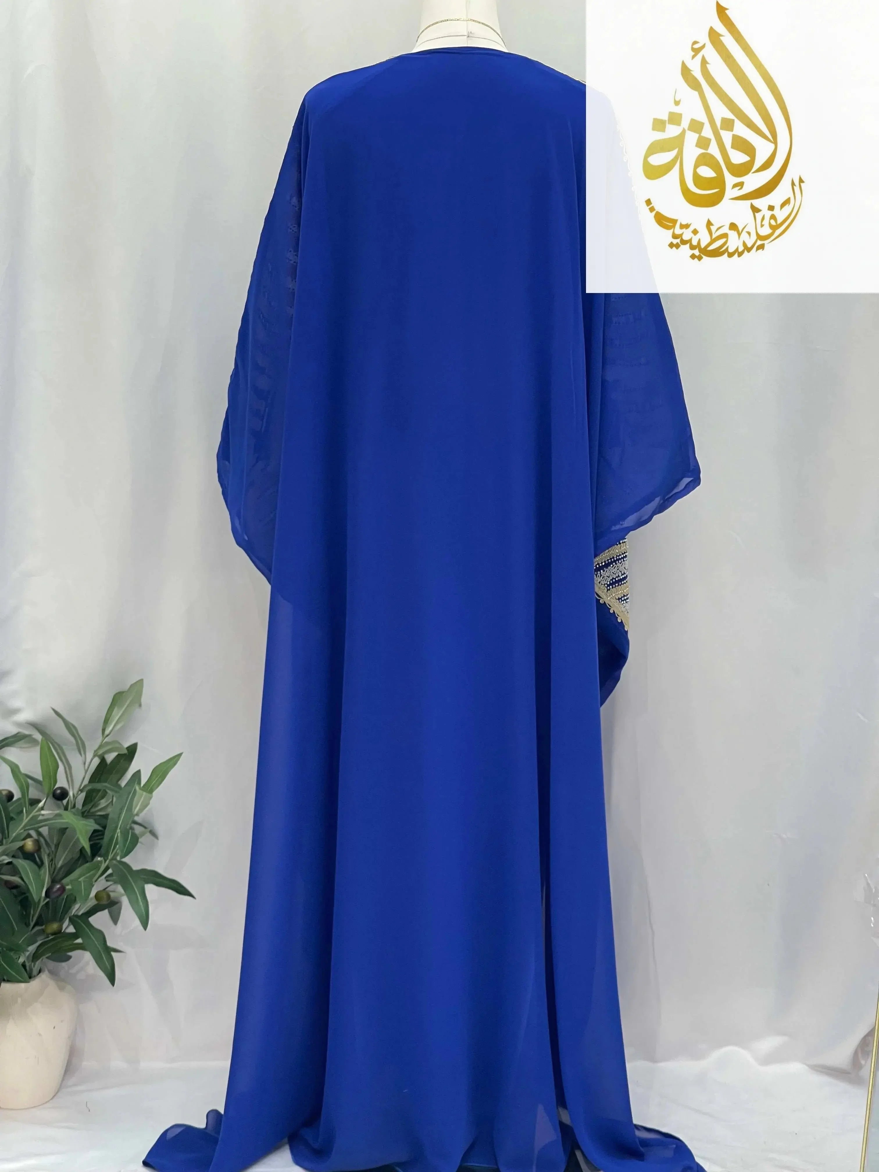 Back view of Dana Free Size Kaftan Abaya in royal blue by Palestinian Elegance with flowing fabric and loose fit