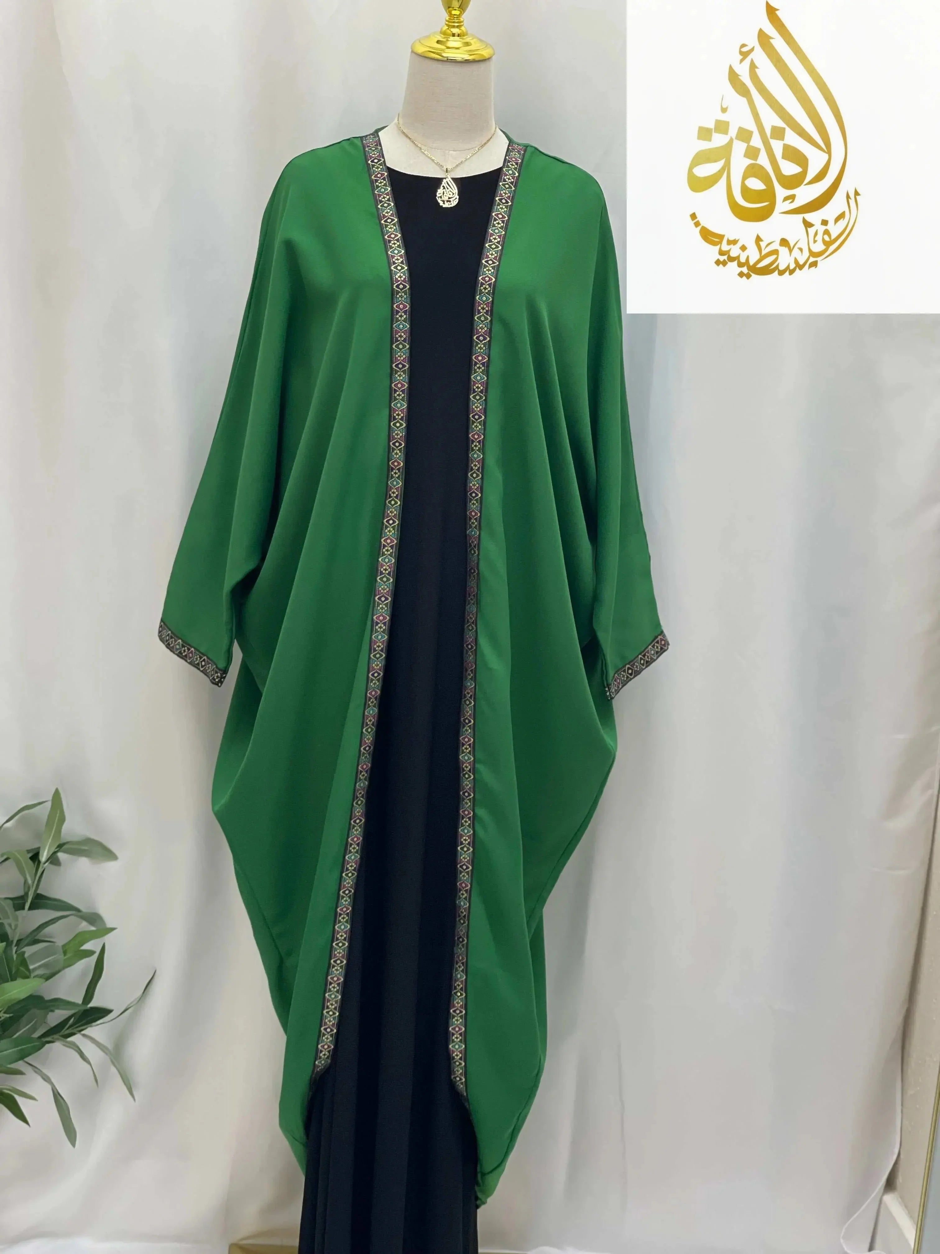 Palestinian Elegance Dana Free Size Kimono green cardigan with decorative trim on a mannequin