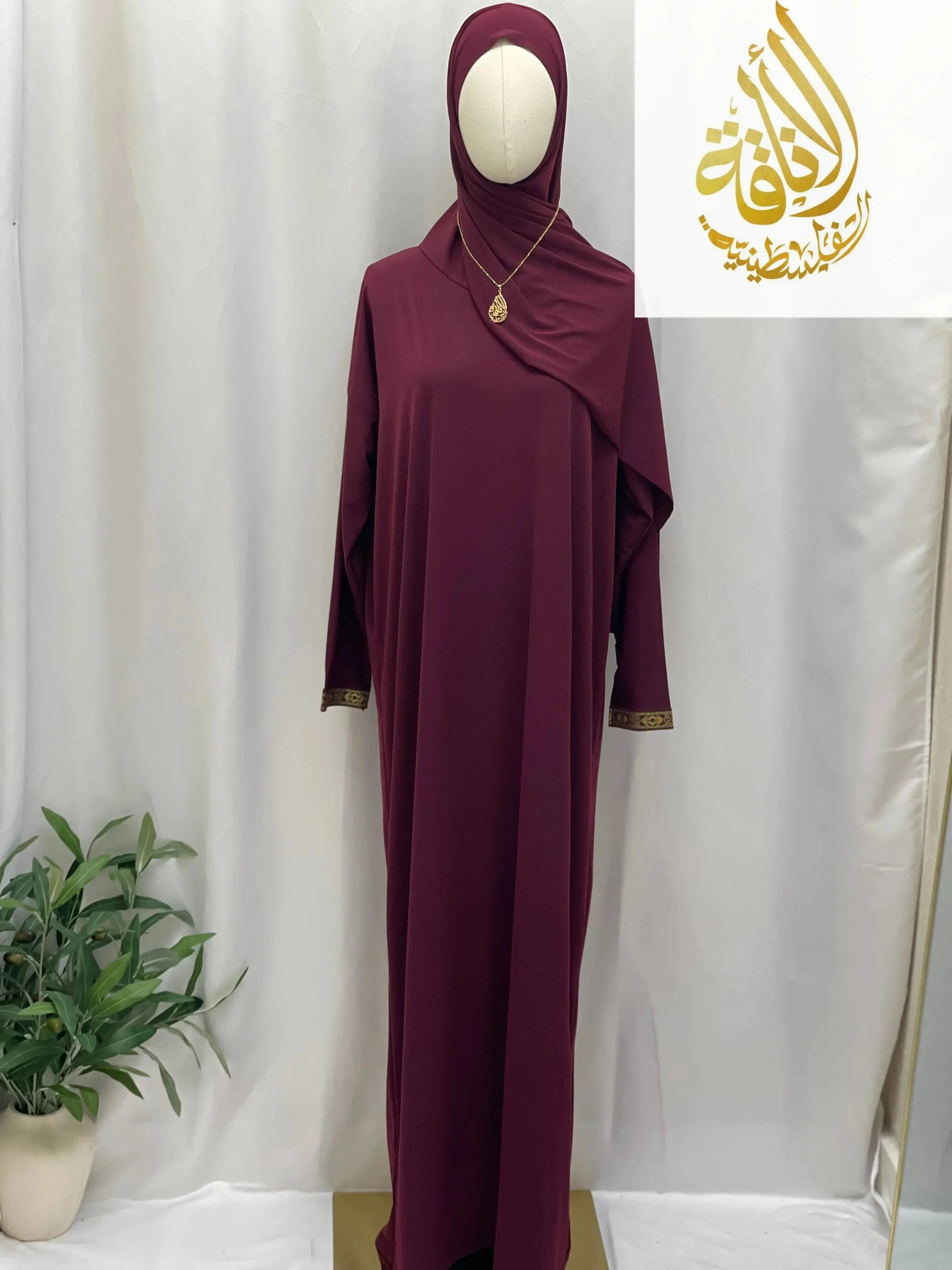 Palestinian Elegance maroon one piece prayer dress abaya with gold trim on sleeves and matching headscarf