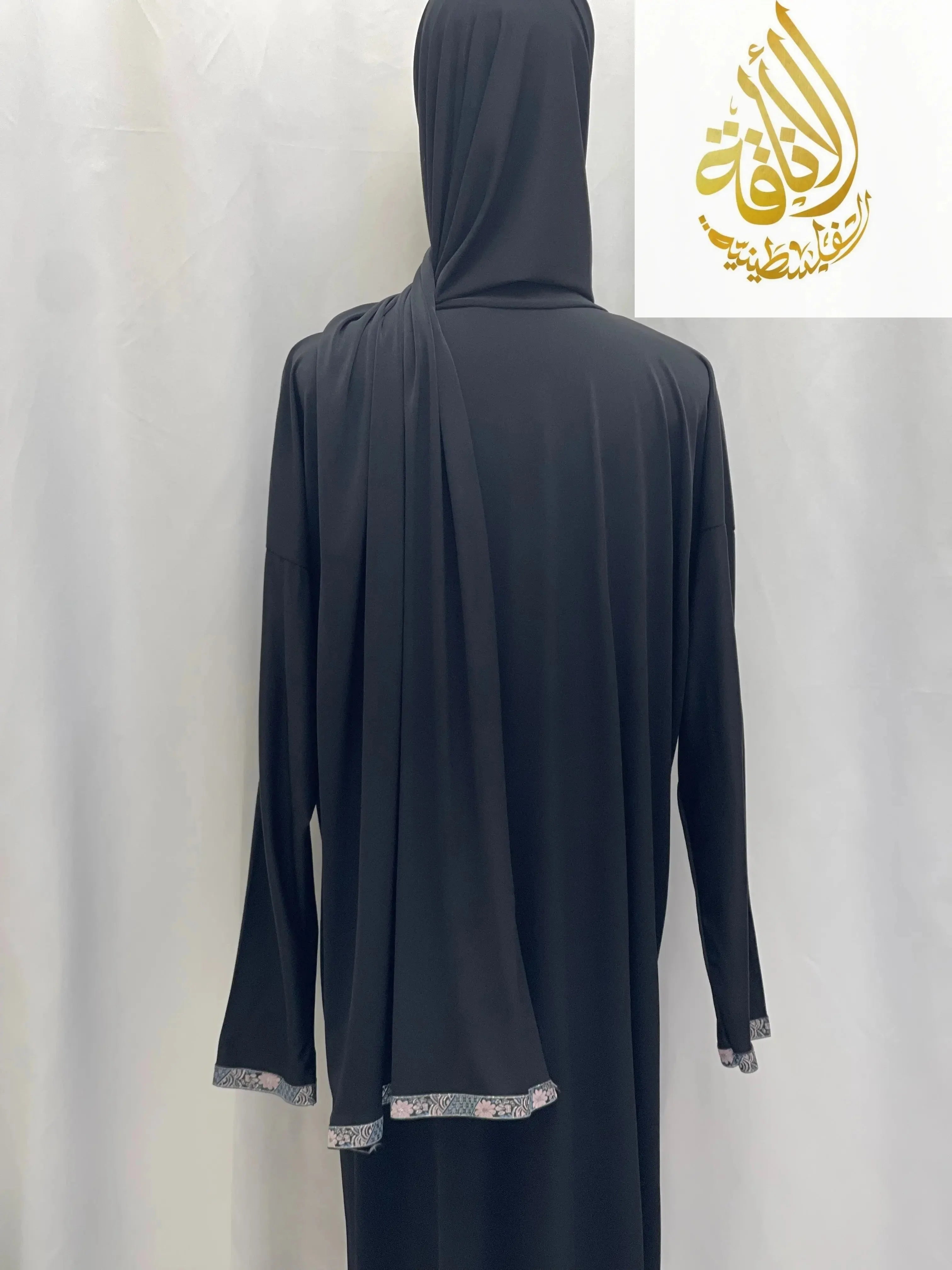 Back view of black Palestinian Elegance one piece prayer dress abaya with lace trim on sleeves