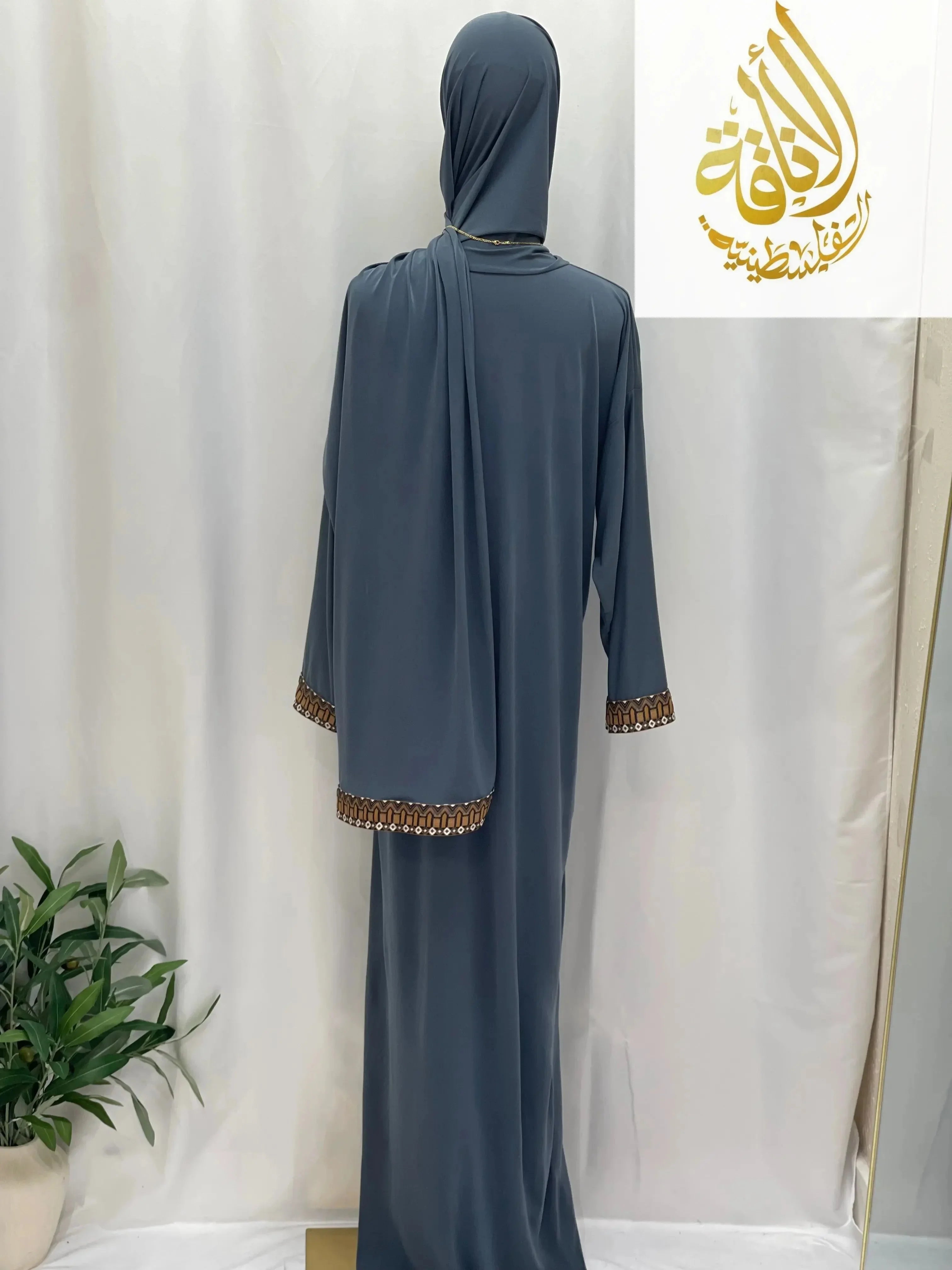 Palestinian Elegance one piece prayer dress in dark gray with decorative cuff and hem details