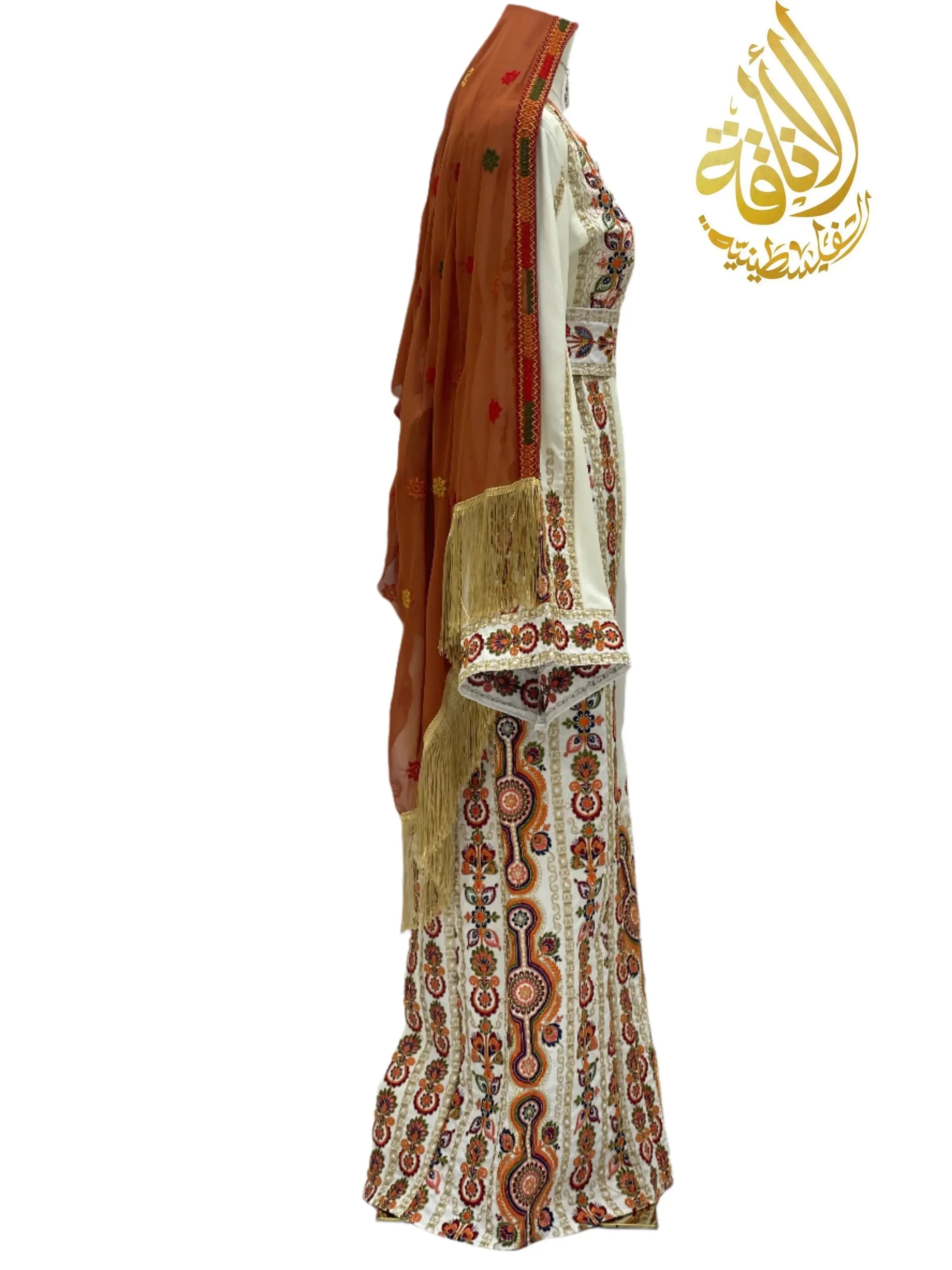 Salma Ivory Embroidered Thoub by Palestinian Elegance displayed on a mannequin with detailed multicolor embroidery and a brown shawl