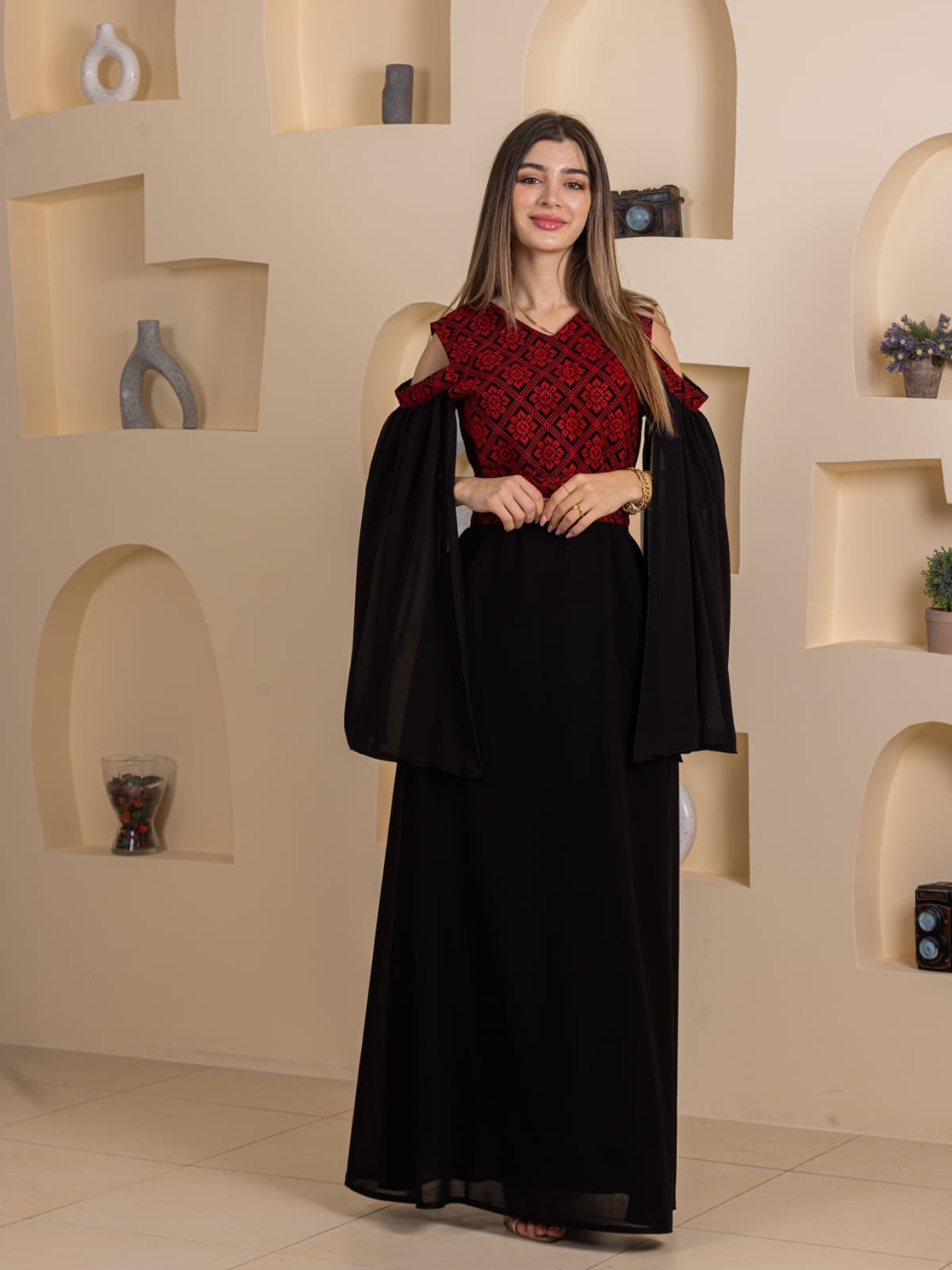 Palestinian Essence Dress black floor length gown with red embroidered bodice and flowing off shoulder sleeves