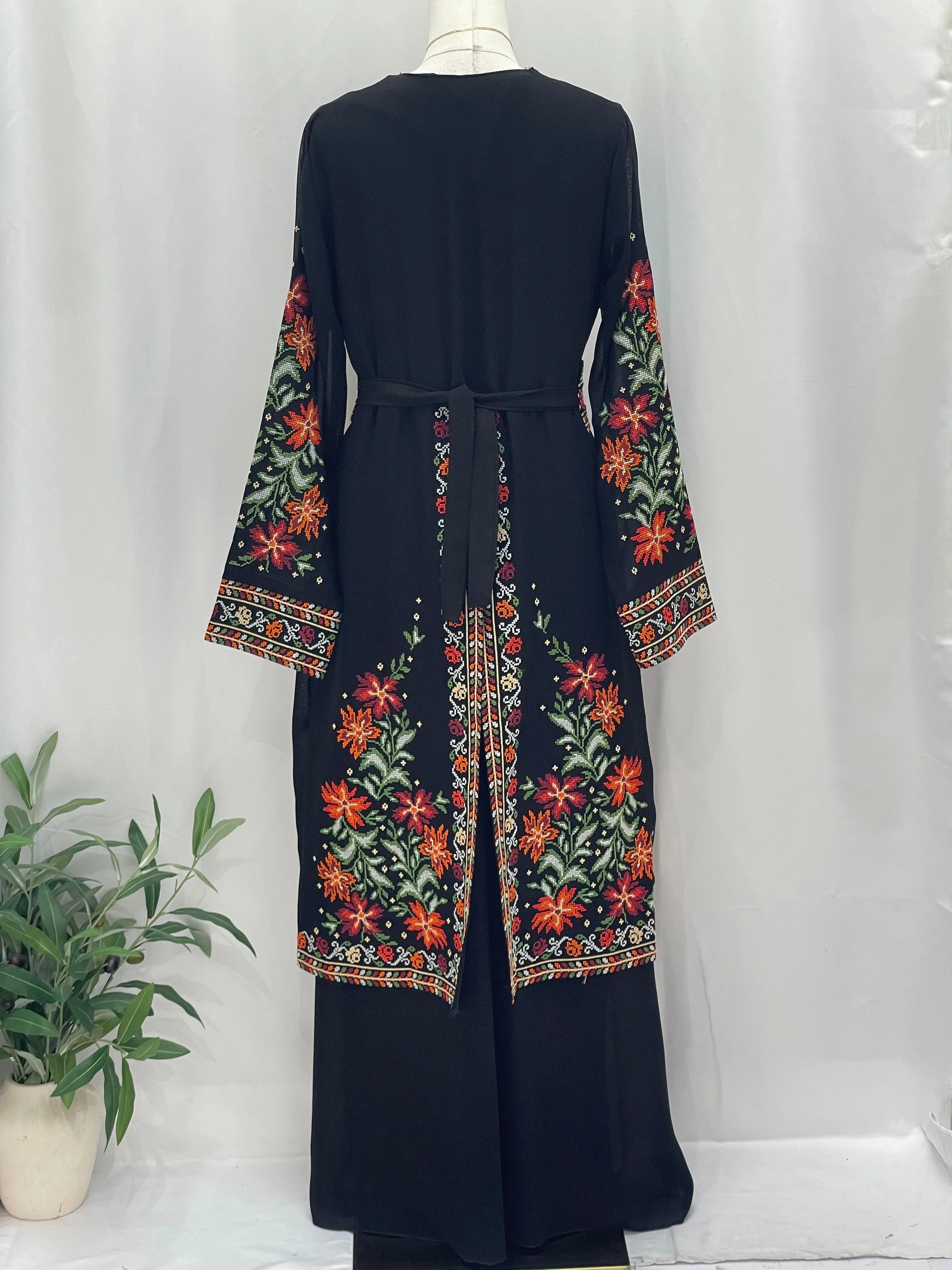 Back view of a Rose Embroidered Dress Abaya featuring colorful floral embroidery and a tied waist