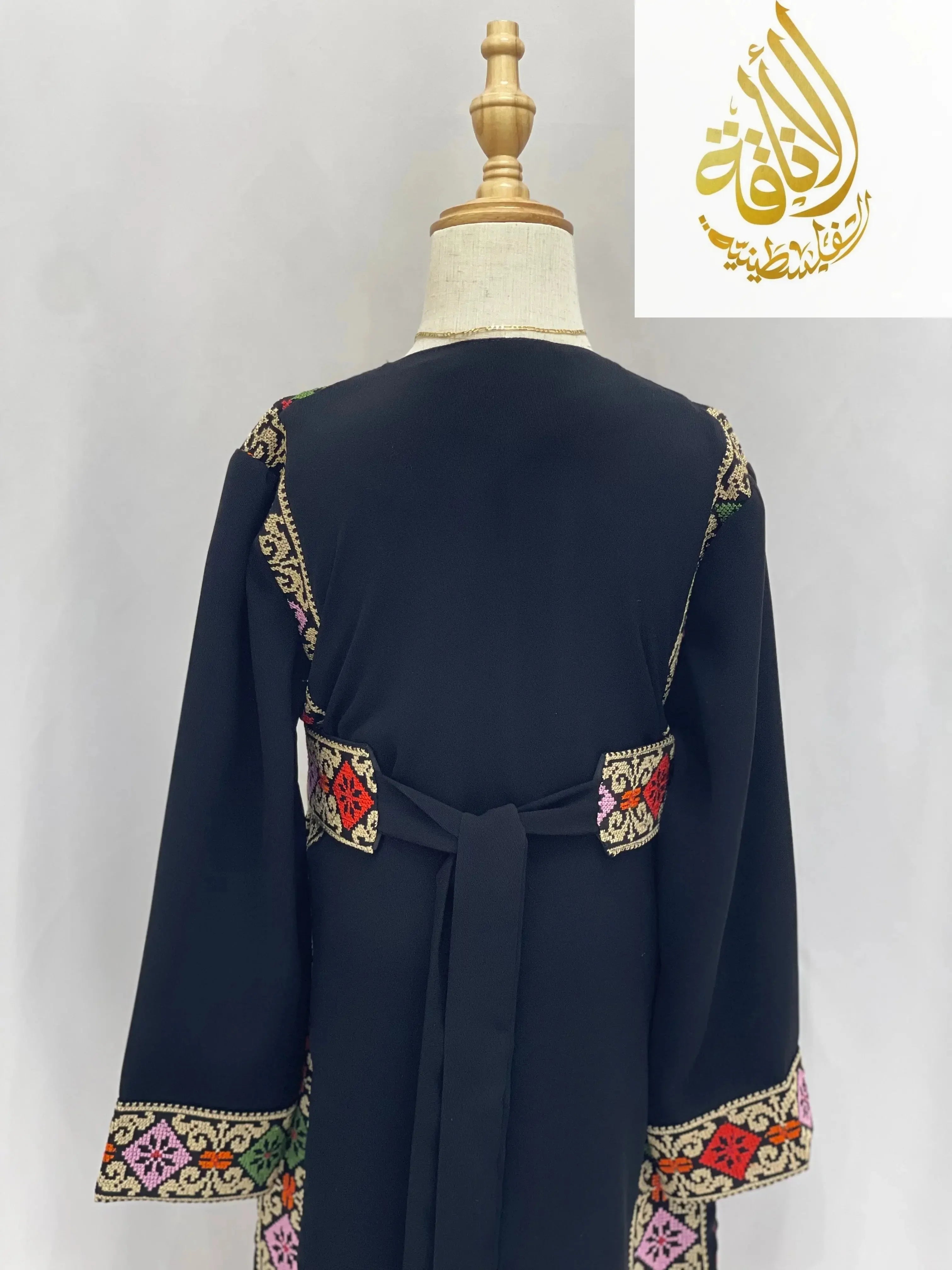 Black embroidered thoub for girls with colorful traditional embroidery on sleeves and back by Palestinian Elegance