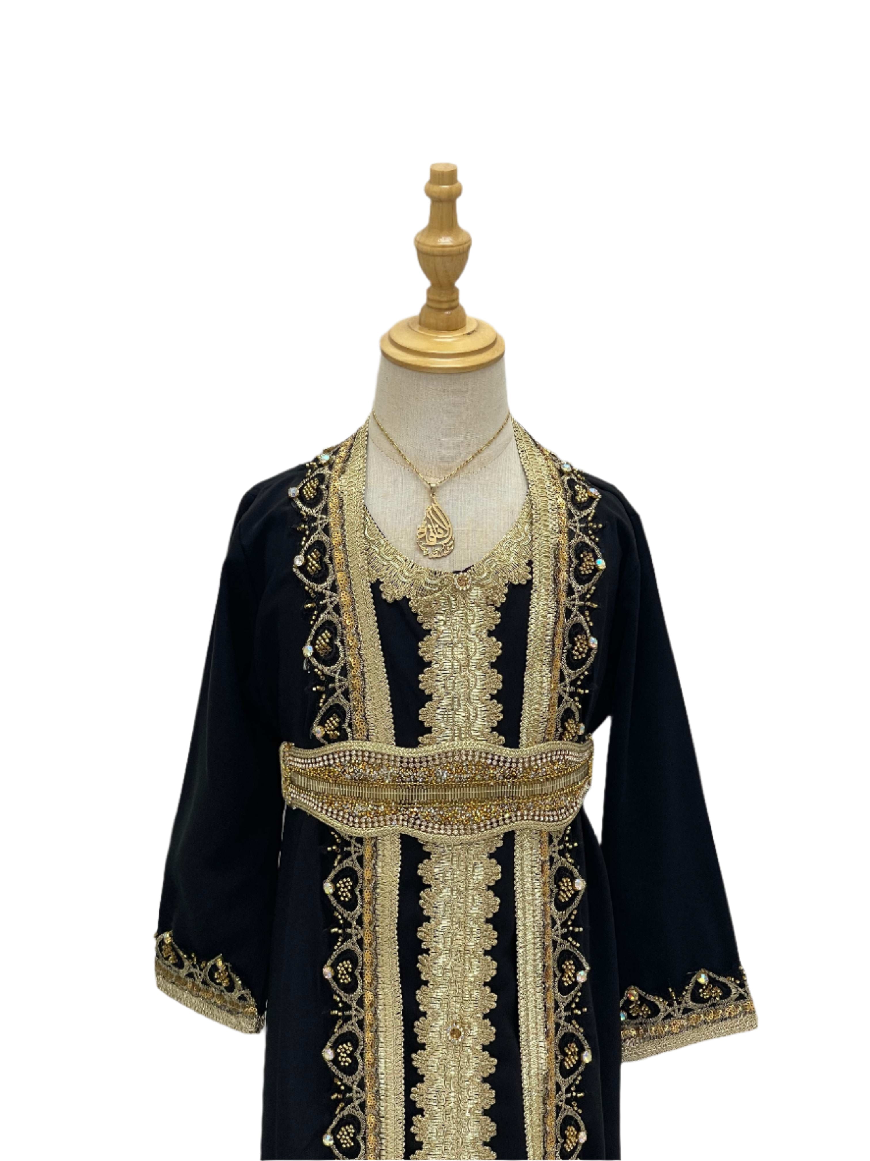 Palestinian Elegance Princess Mariam Long Sleeve Kaftan Dress in black with gold embroidery on a display mannequin