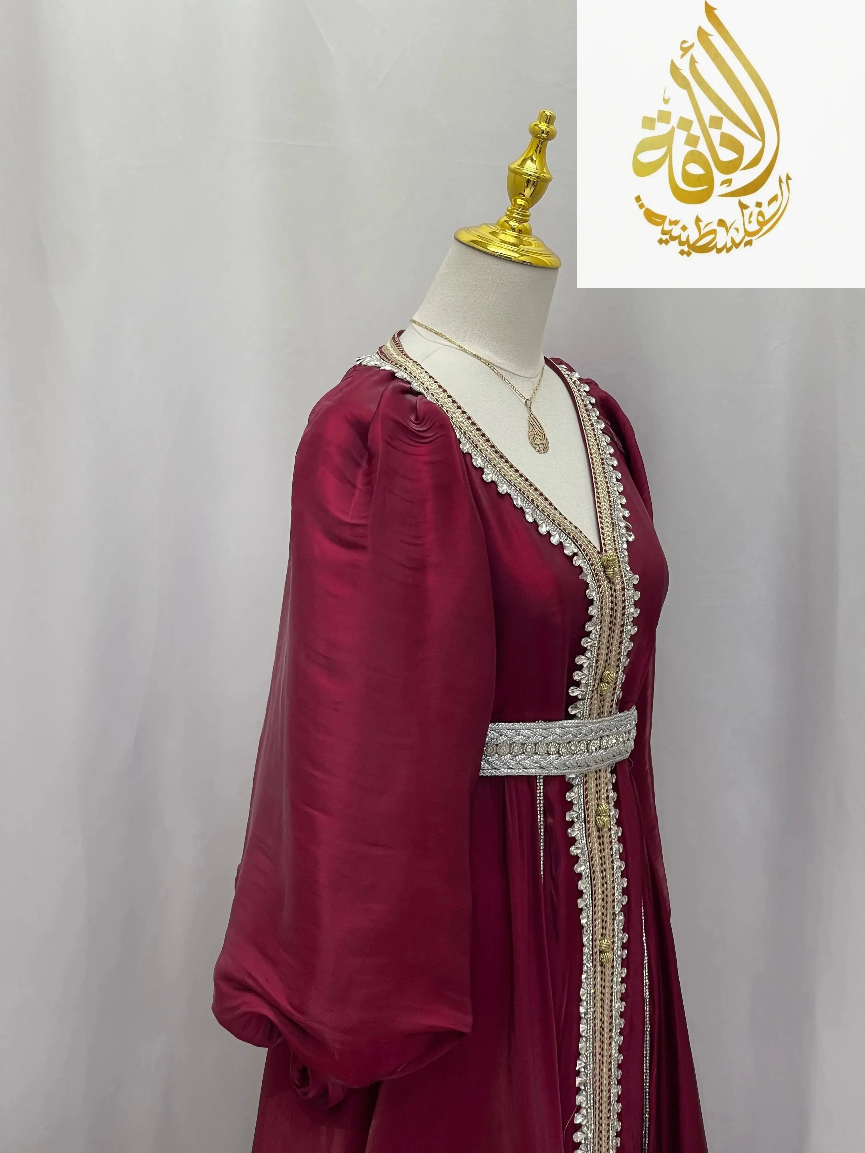 Palestinian Elegance puffy sleeves kaftan dress in deep red with decorative trim and a silver belt