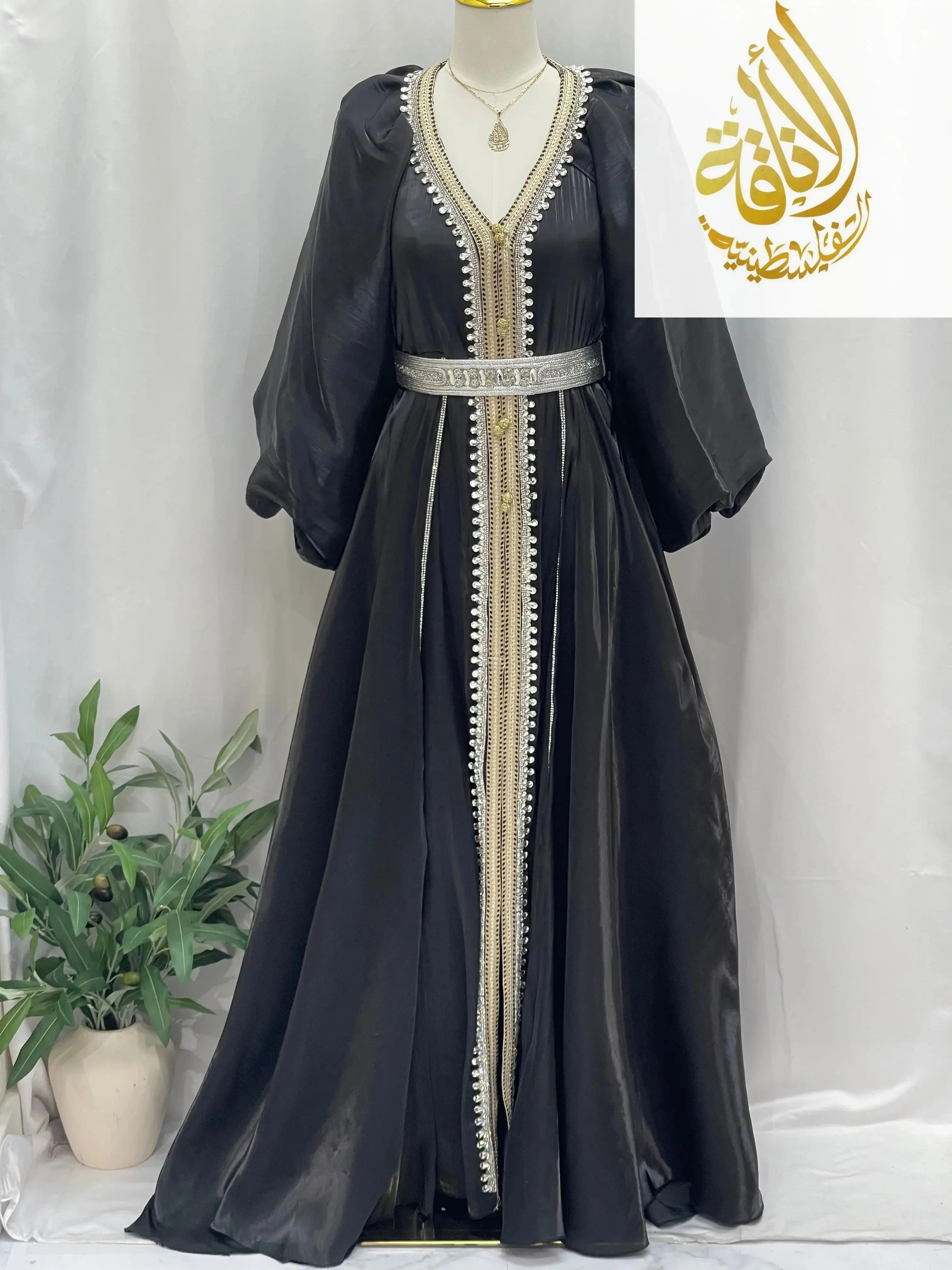 Palestinian Elegance black puffy sleeves kaftan dress with gold and silver embroidery and belt