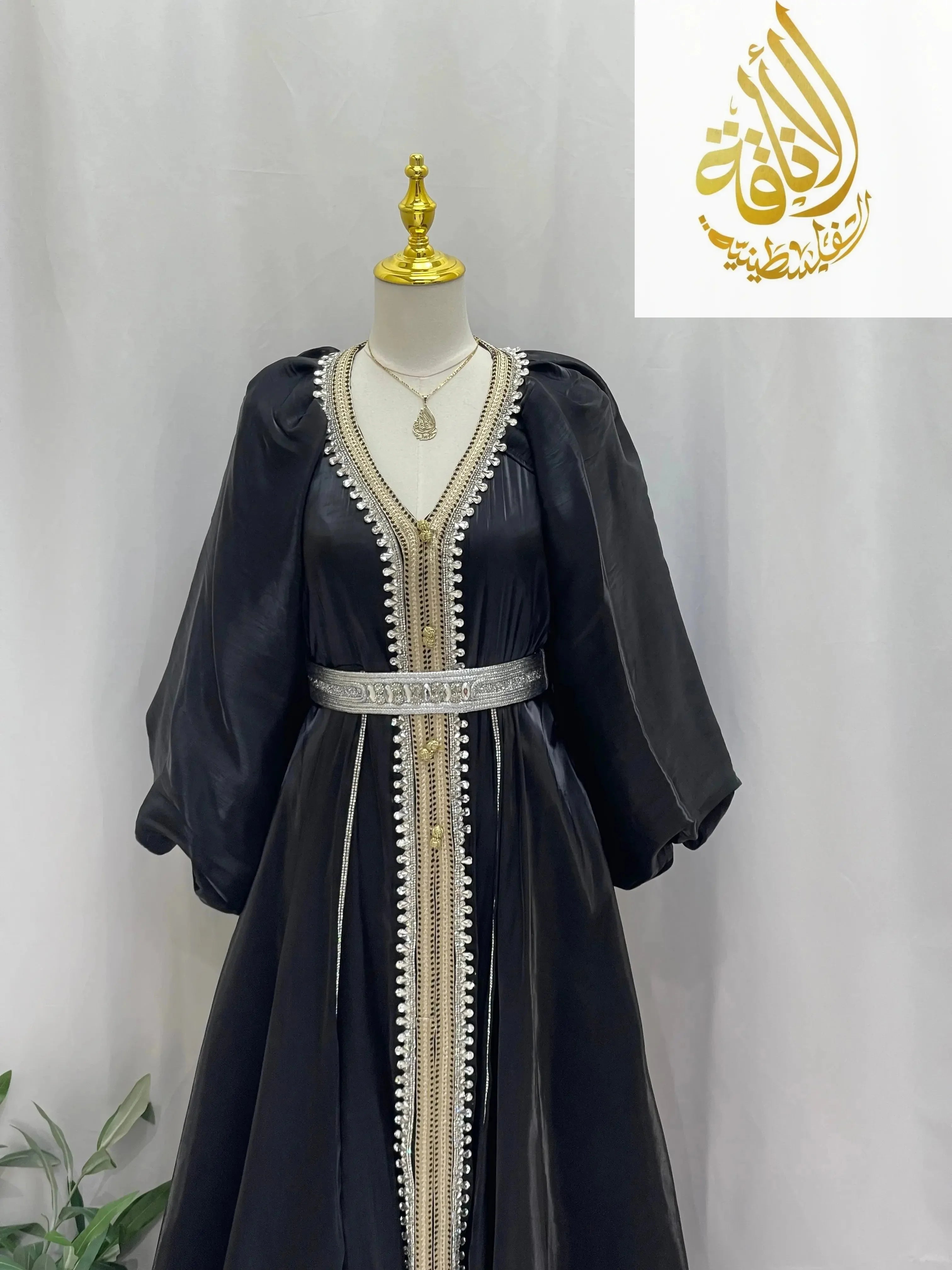 Palestinian Elegance black puffy sleeves kaftan dress with silver belt and intricate trim details