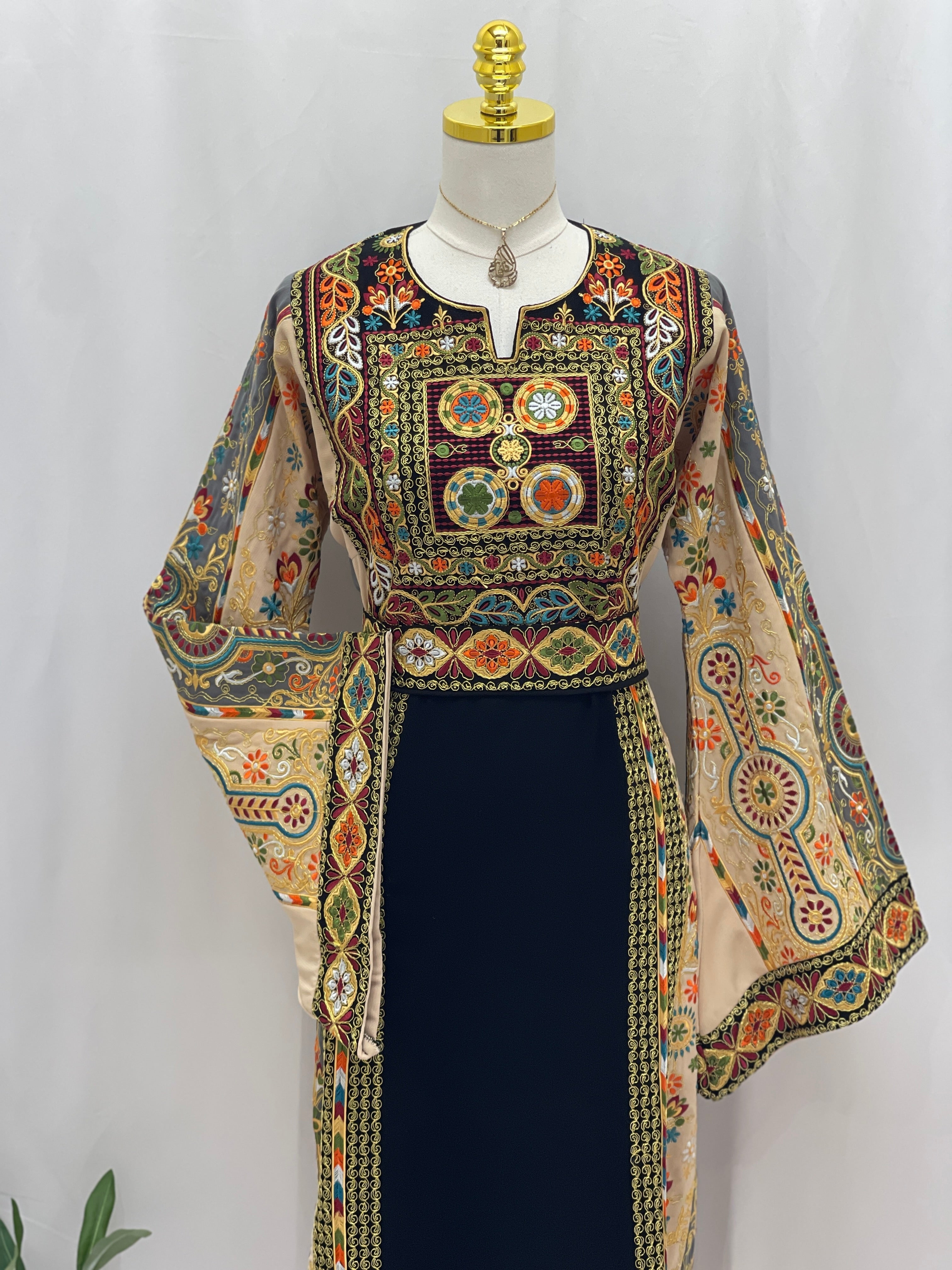 Rafif Embroidered Thobe by Palestinian Elegance navy dress with intricate multicolor Palestinian embroidery and wide bell sleeves