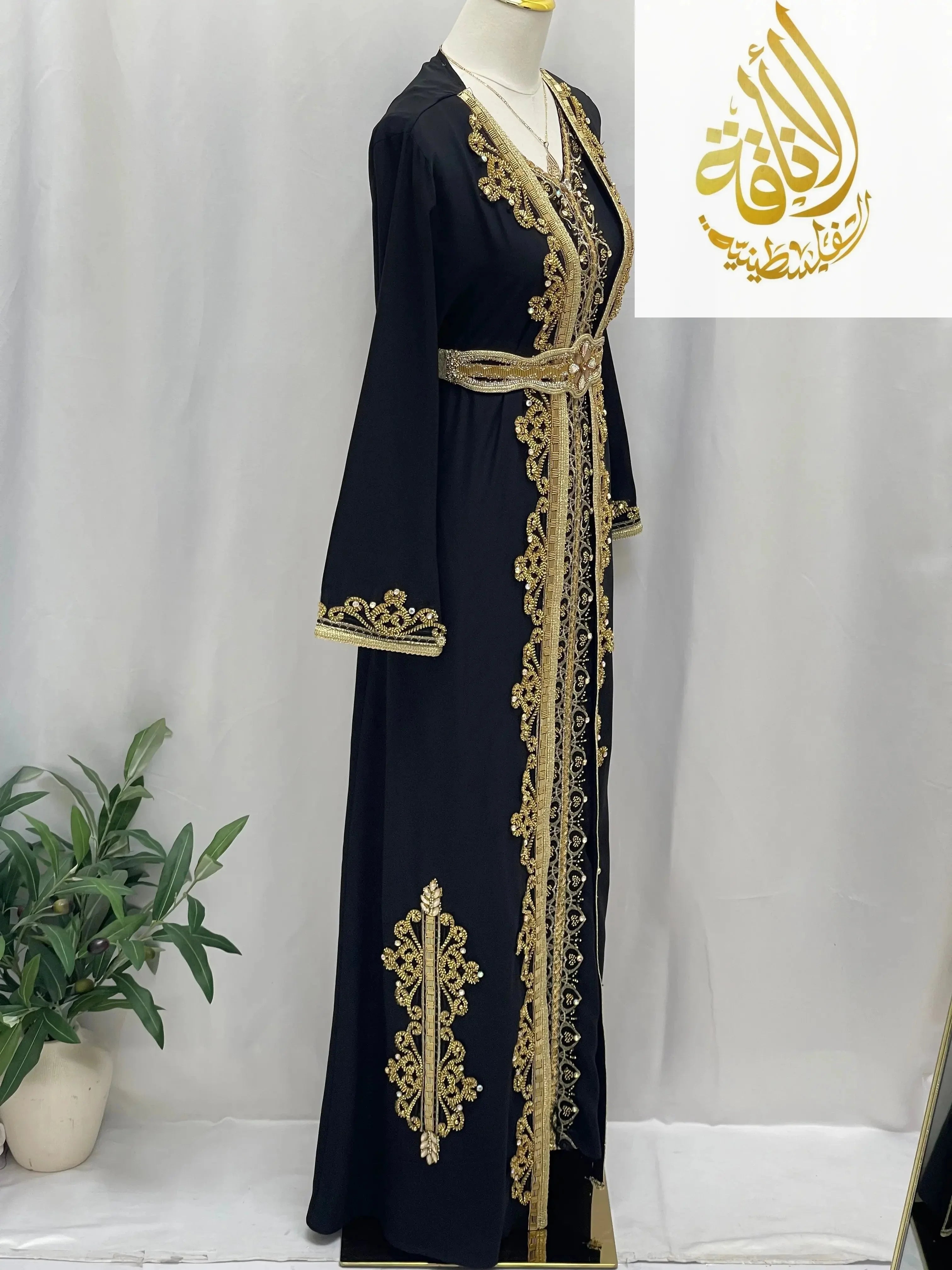 Rahaf Moroccan Style Kaftan by Palestinian Elegance black with intricate gold embroidery and a matching belt