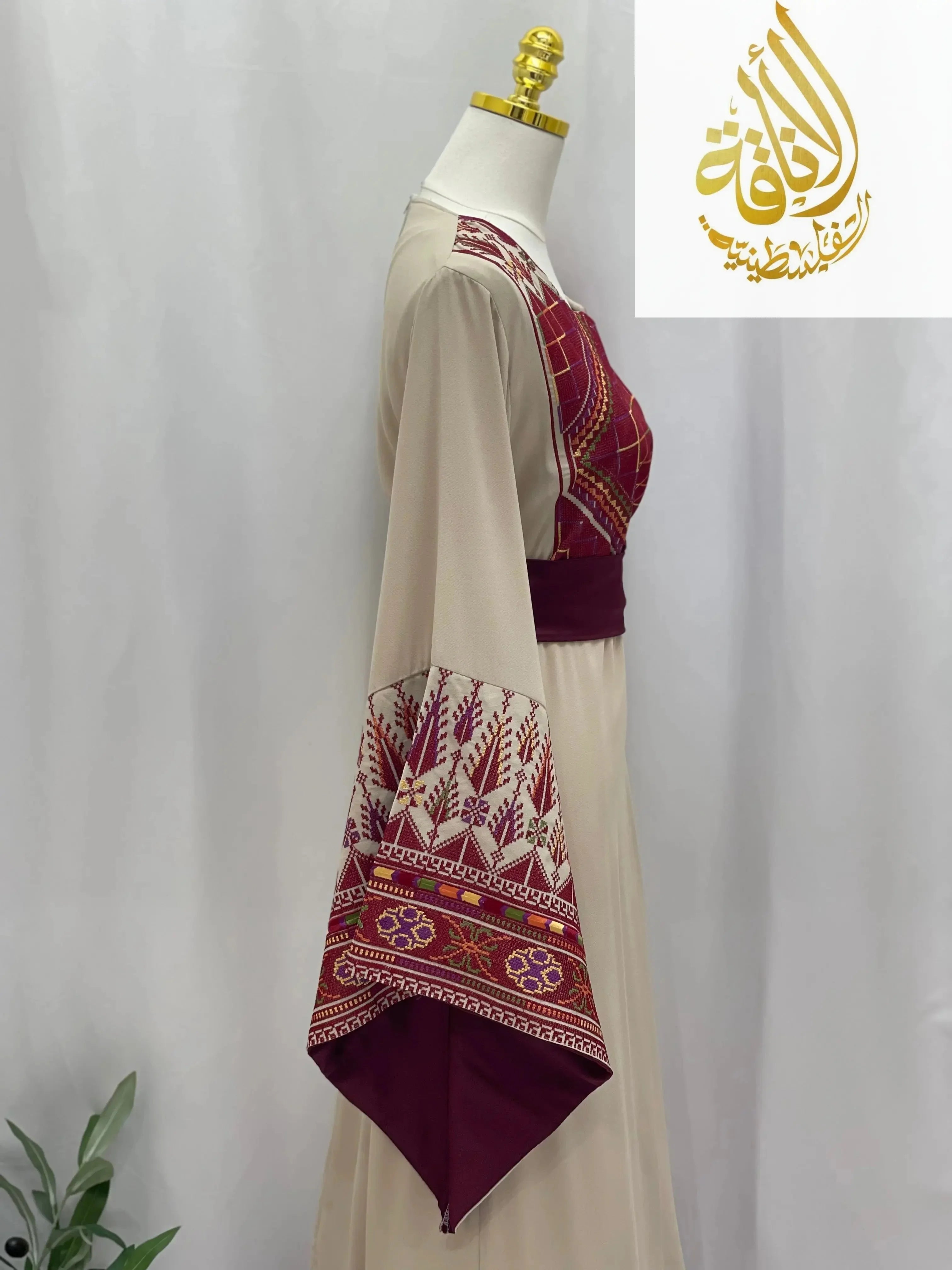 Randa Embroidered Thoub by Palestinian Elegance showcasing detailed maroon embroidery on beige thobe sleeve